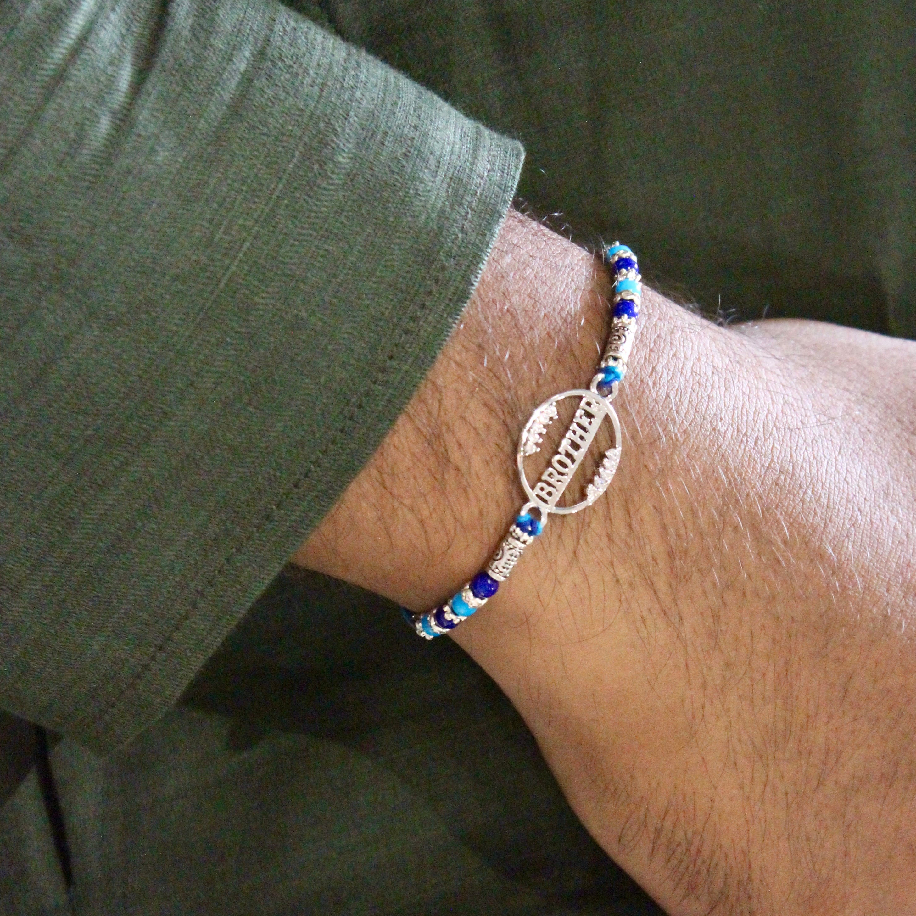 'BROTHER' blue thread rakhi in 925 silver
