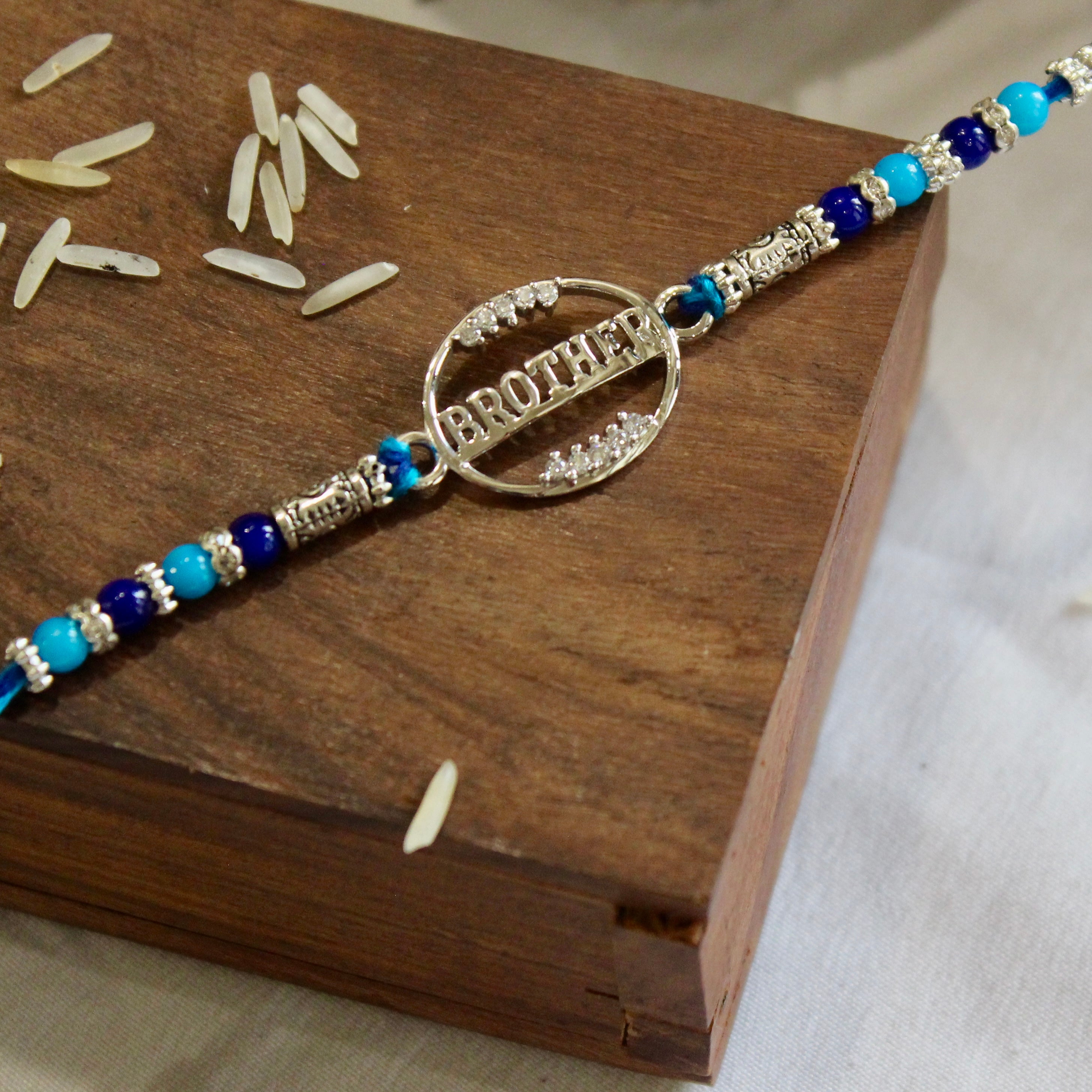 'BROTHER' blue thread rakhi in 925 silver