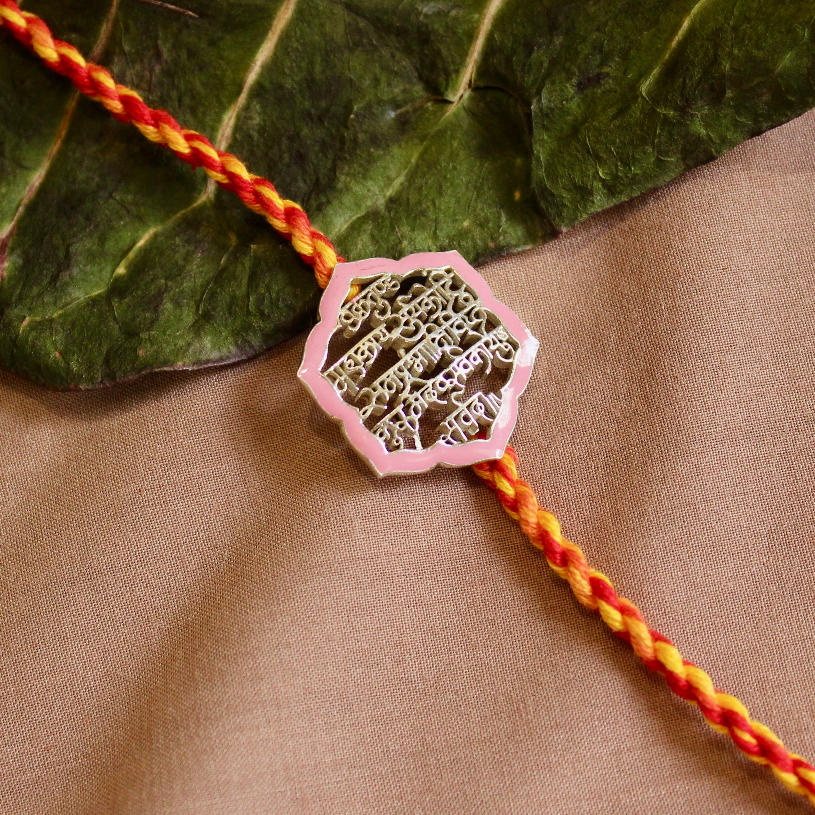 'Shlok' Red Yellow Thread Pink Rakhi in 925 Silver