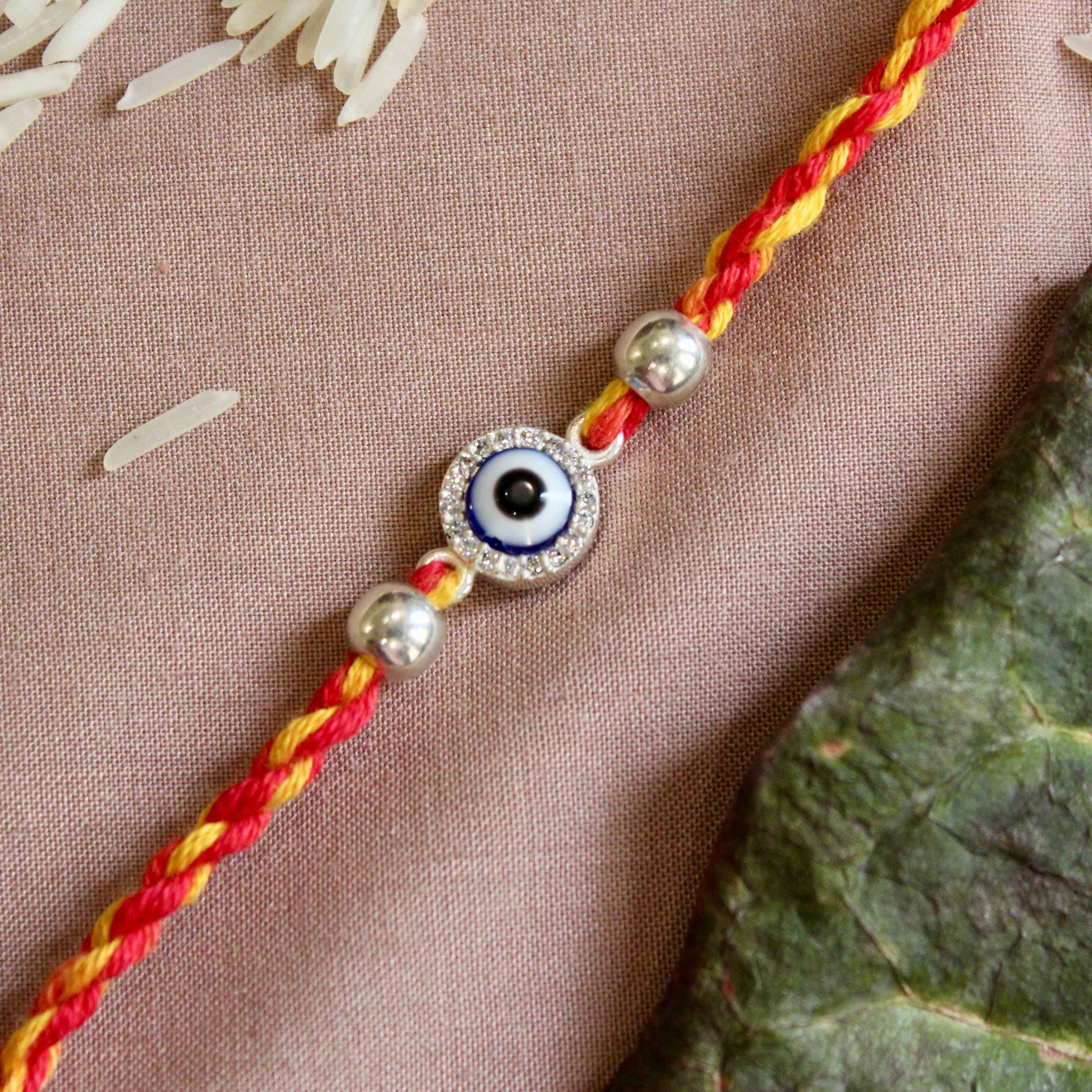 Evil eye red yellow thread silver rakhi