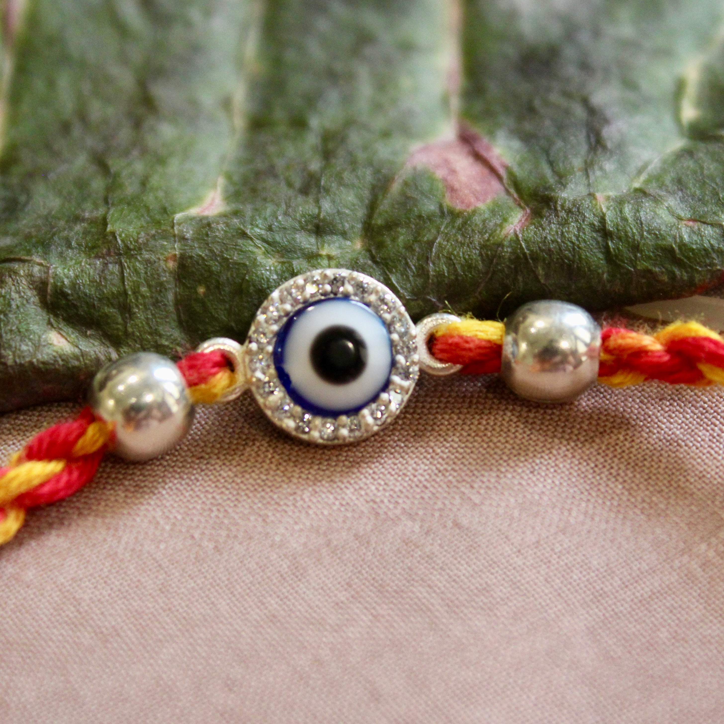 Evil eye red yellow thread silver rakhi