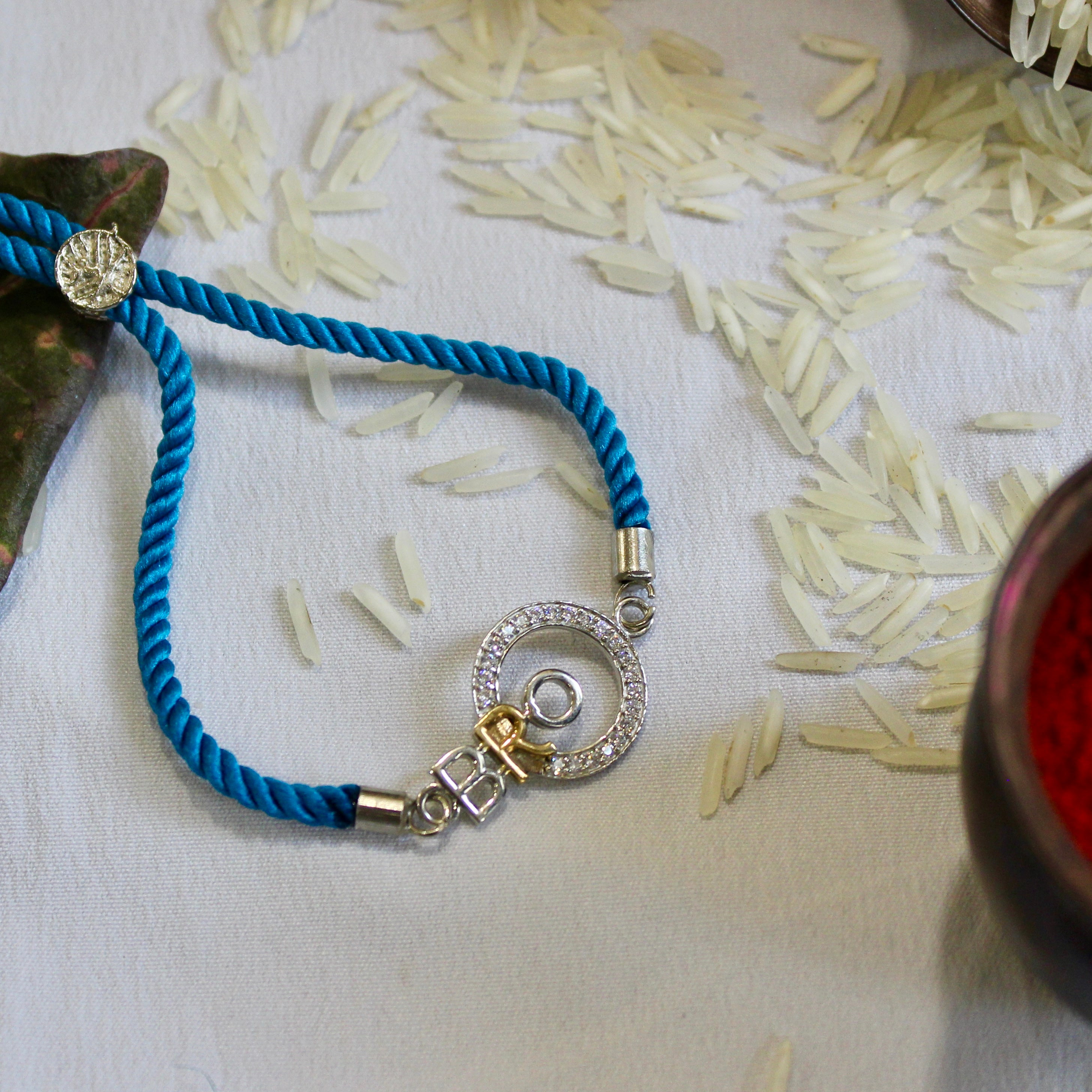 'Bro With Circle' Blue Thread Rakhi in 925 Silver