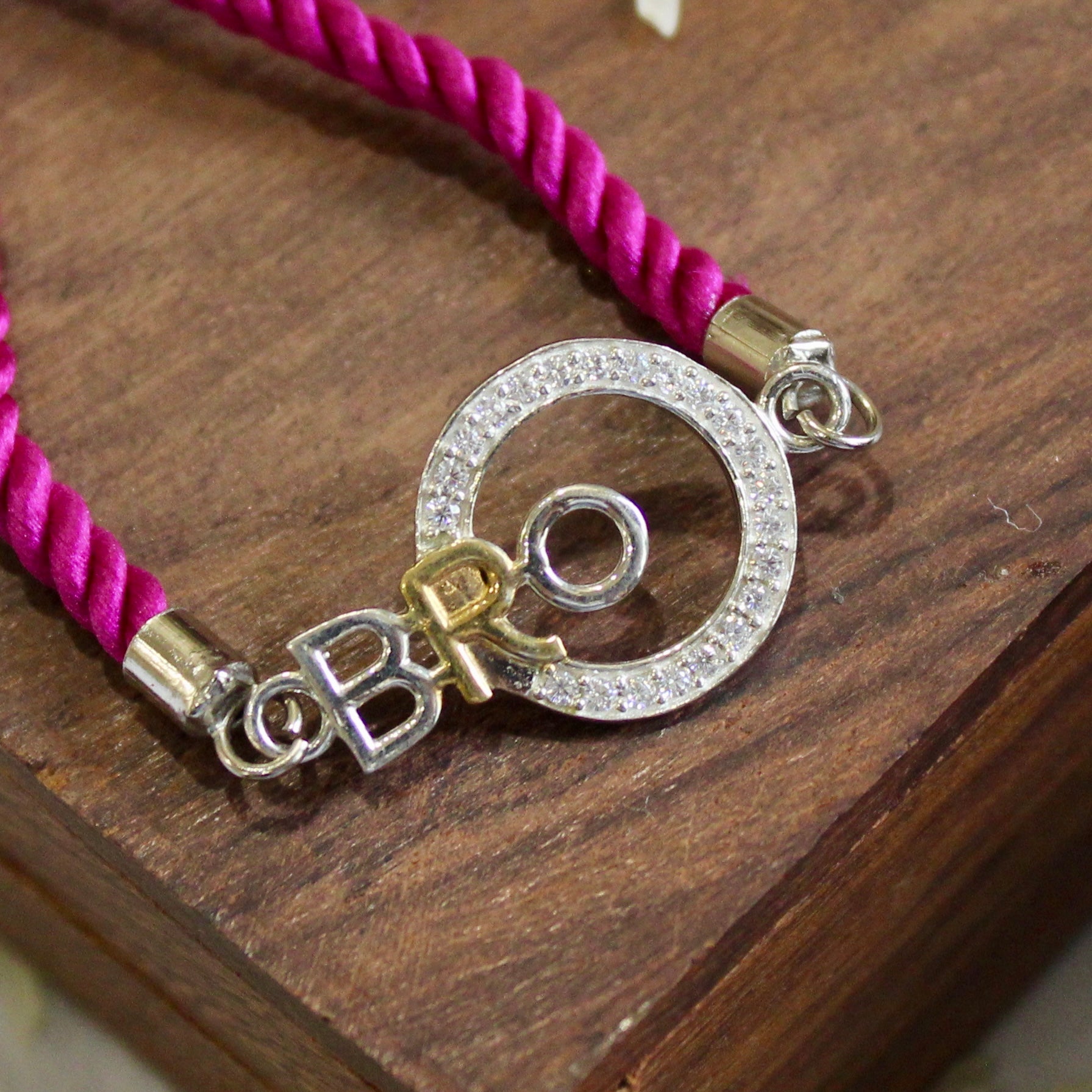 'BRO with circle' purple thread rakhi in 925 Silver