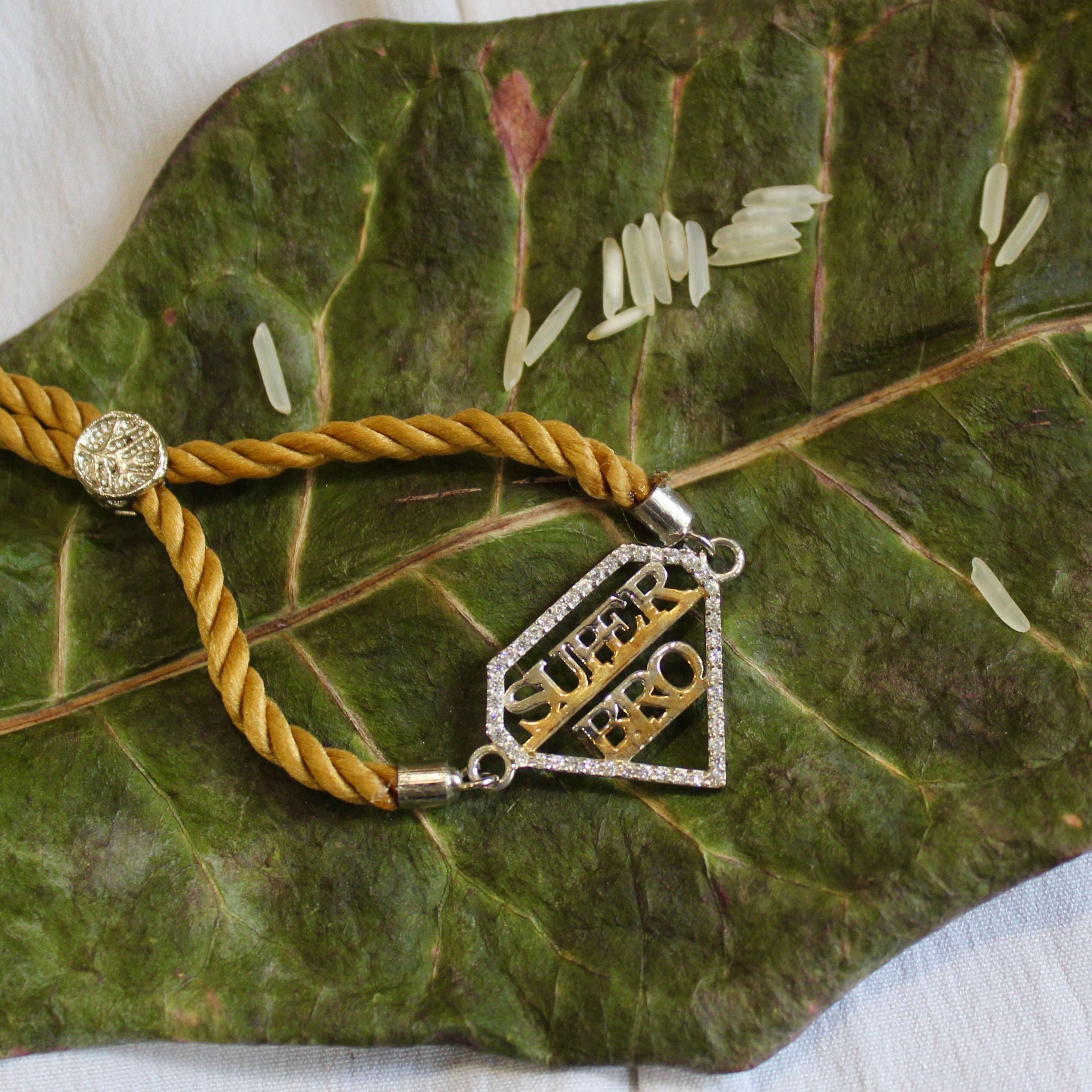 'SUPER BRO' Golden Thread Rakhi in 925 Silver