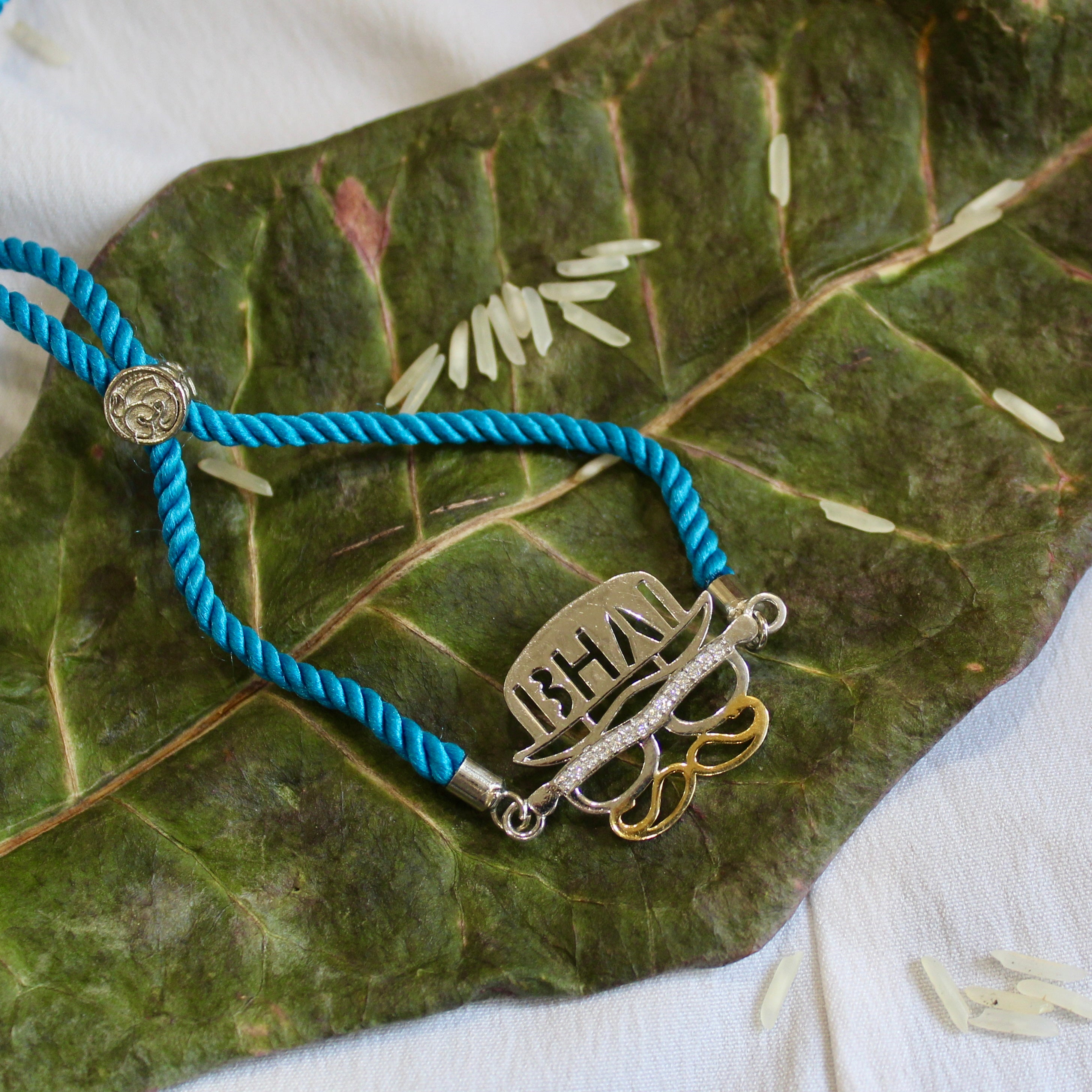 'BHAI WITH HAT' Blue Thread Rakhi in 925 Silver