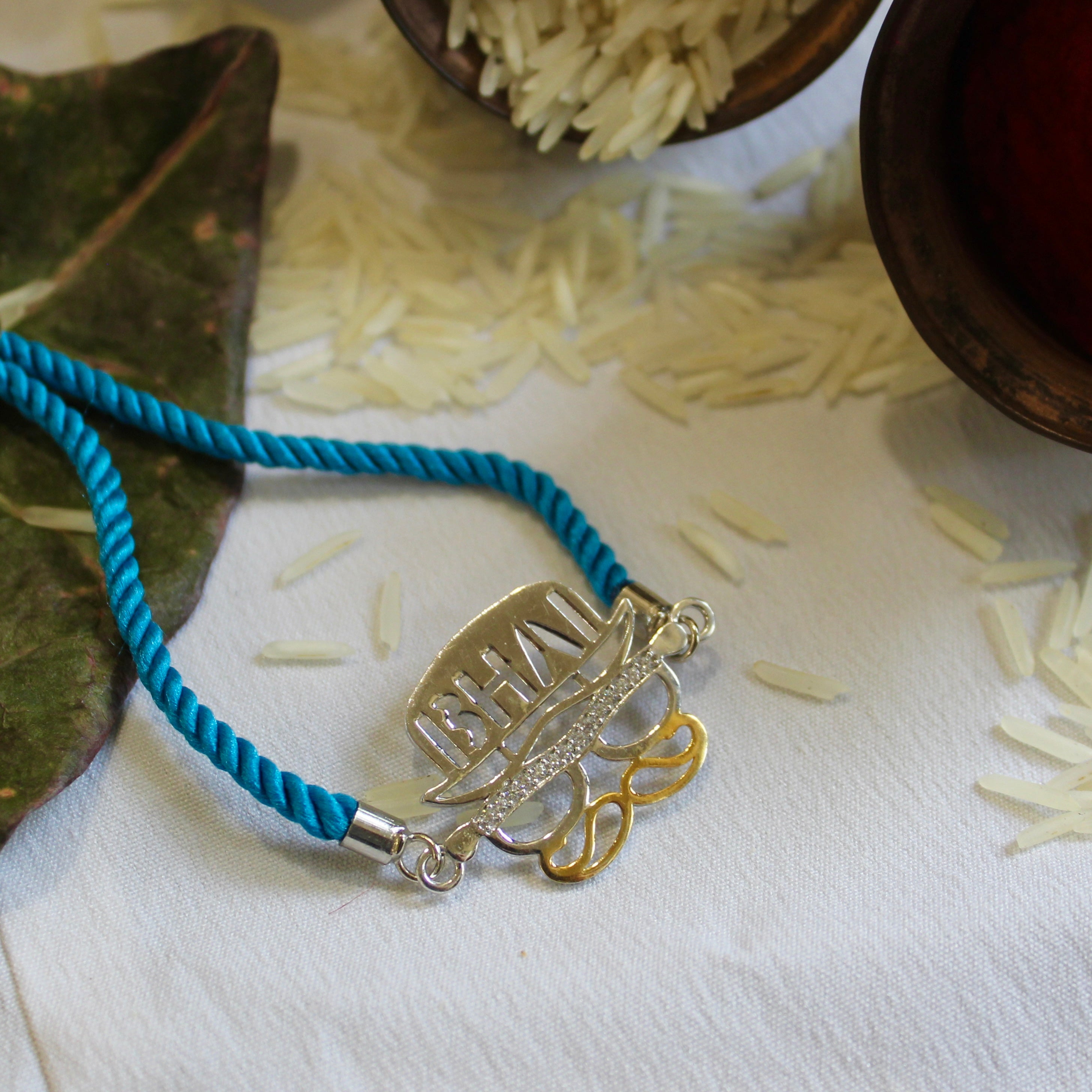 'BHAI WITH HAT' Blue Thread Rakhi in 925 Silver