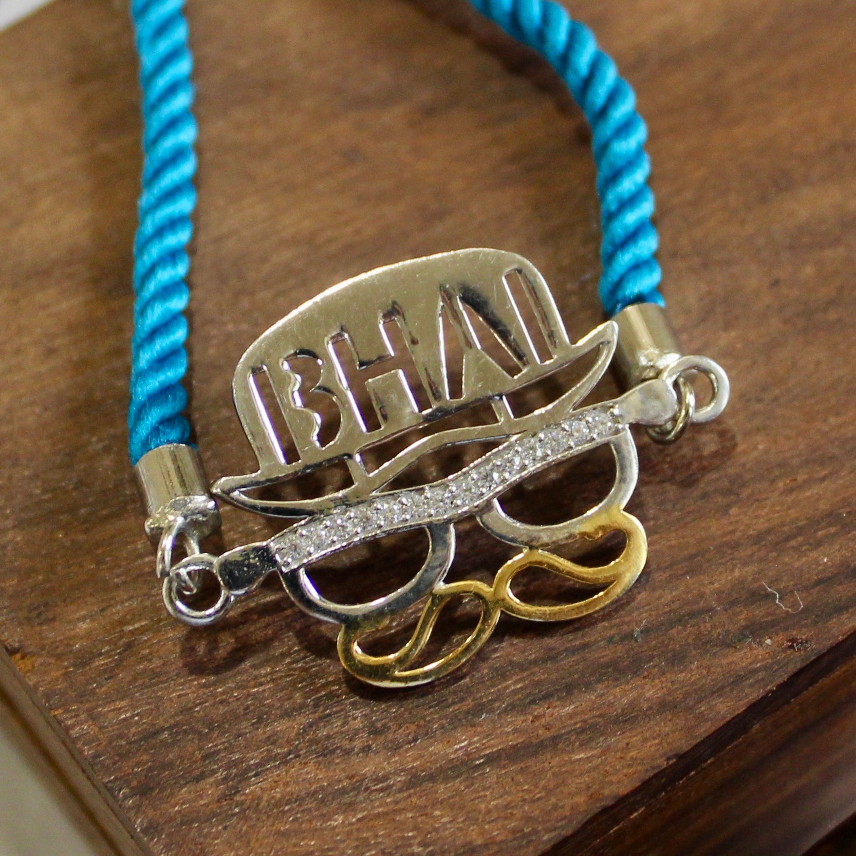 'BHAI WITH HAT' Blue Thread Rakhi in 925 Silver