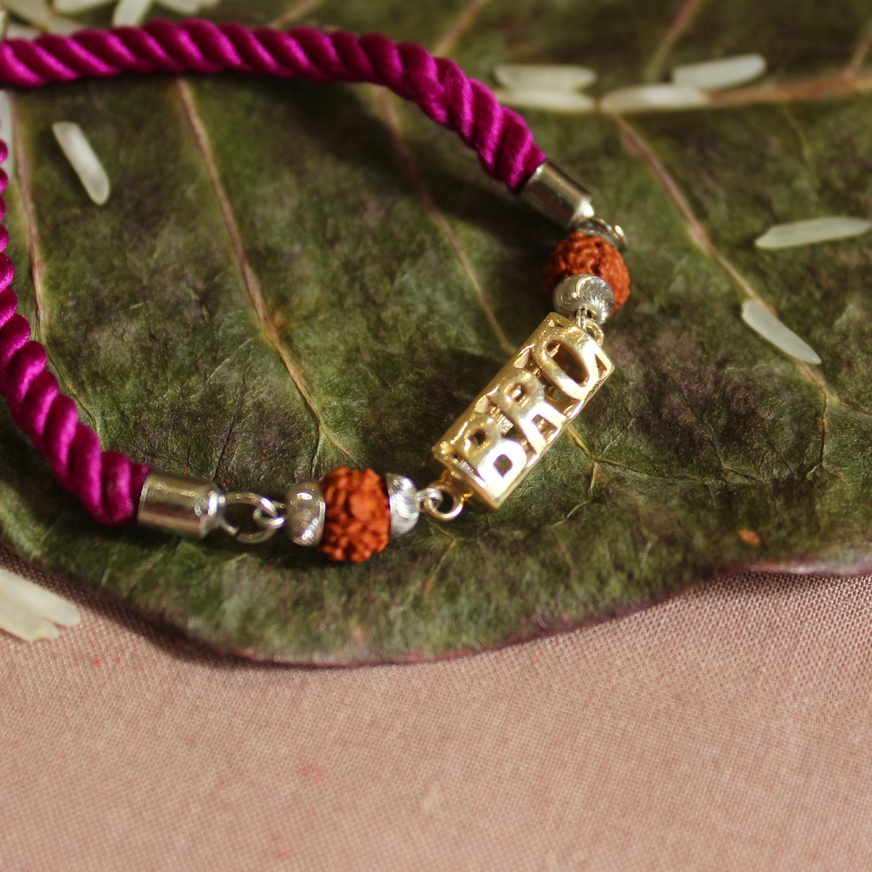 'BRO with Rudraksh' Pink Thread Rakhi in 925 Silver