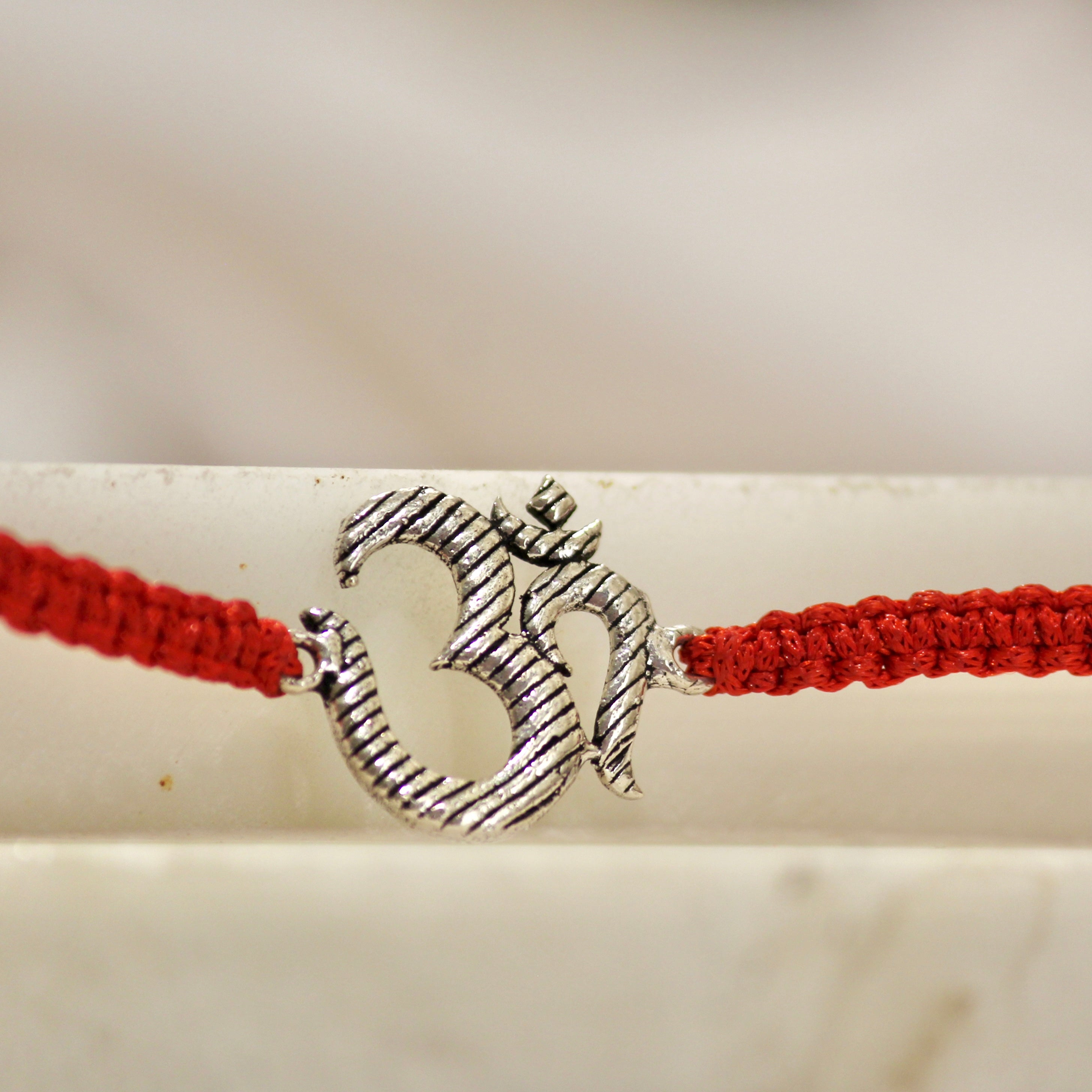 BIG OM red thread rakhi in 925 silver