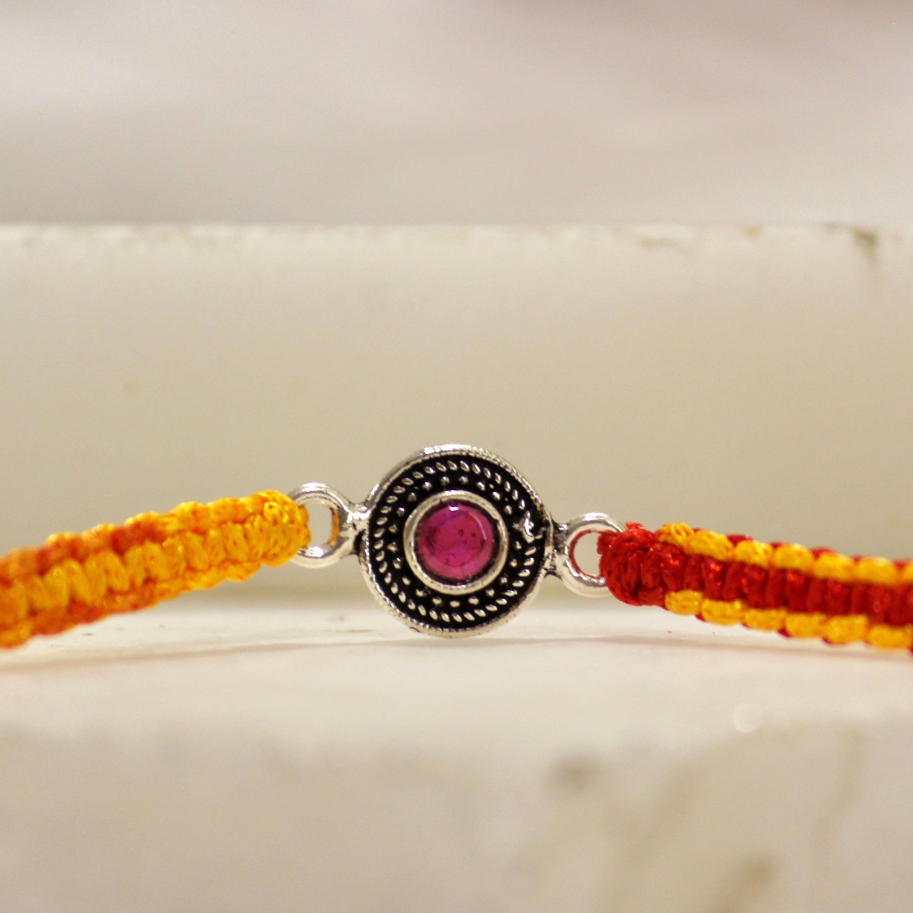 RUBY STONE mini circle red thread rakhi in 925 silver