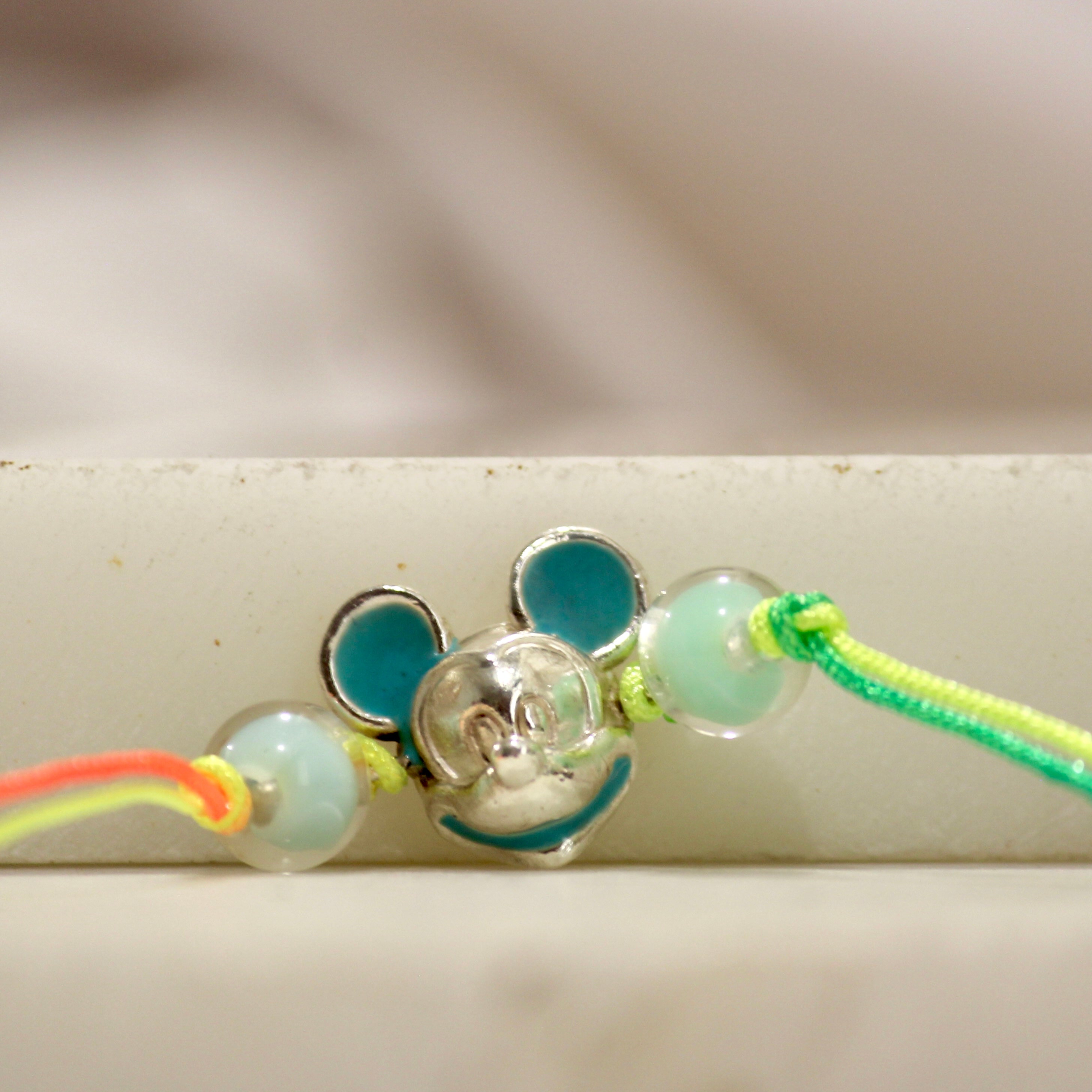 Mickey multi-colored thread rakhi in 925 silver