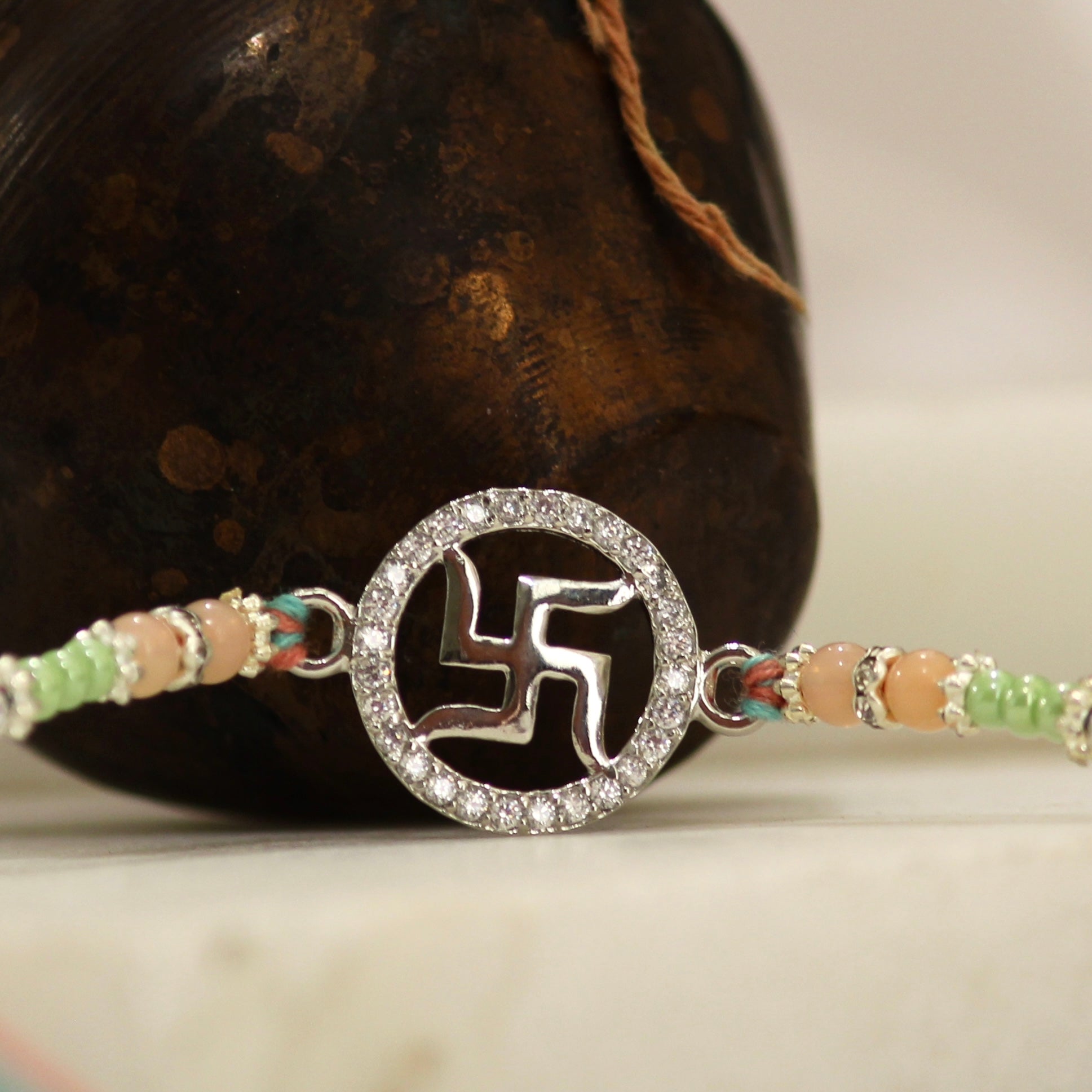 SATIYA peach thread Rakhi in 925 silver