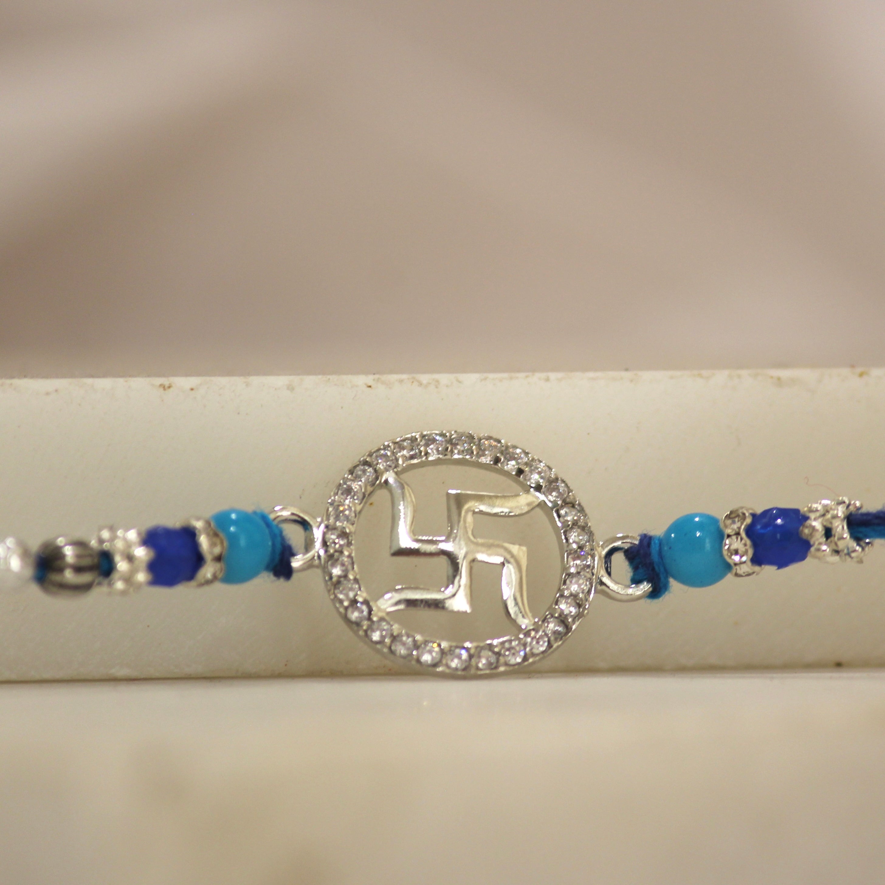 Satiya in circle blue thread rakhi in 925 silver