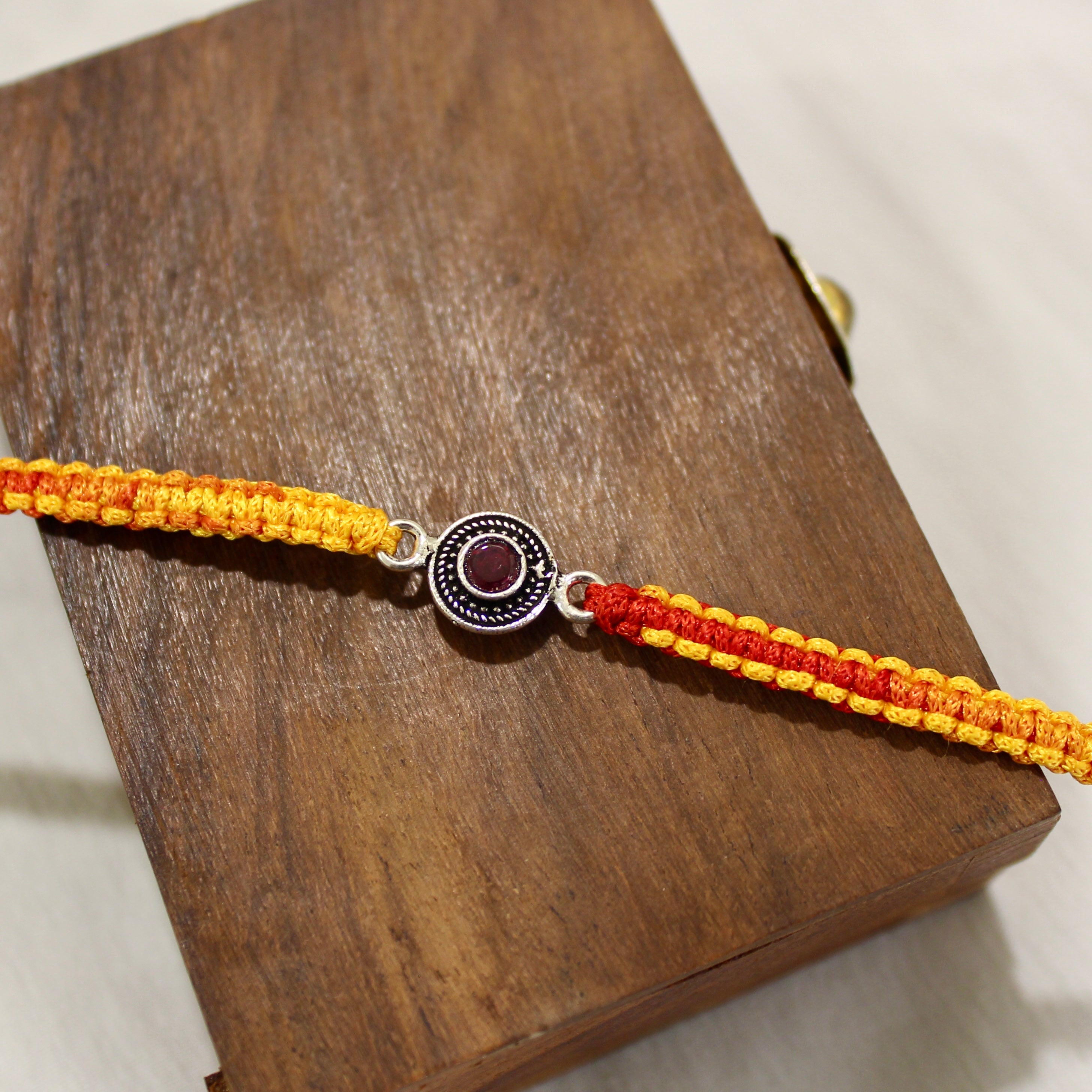 RUBY STONE mini circle red thread rakhi in 925 silver