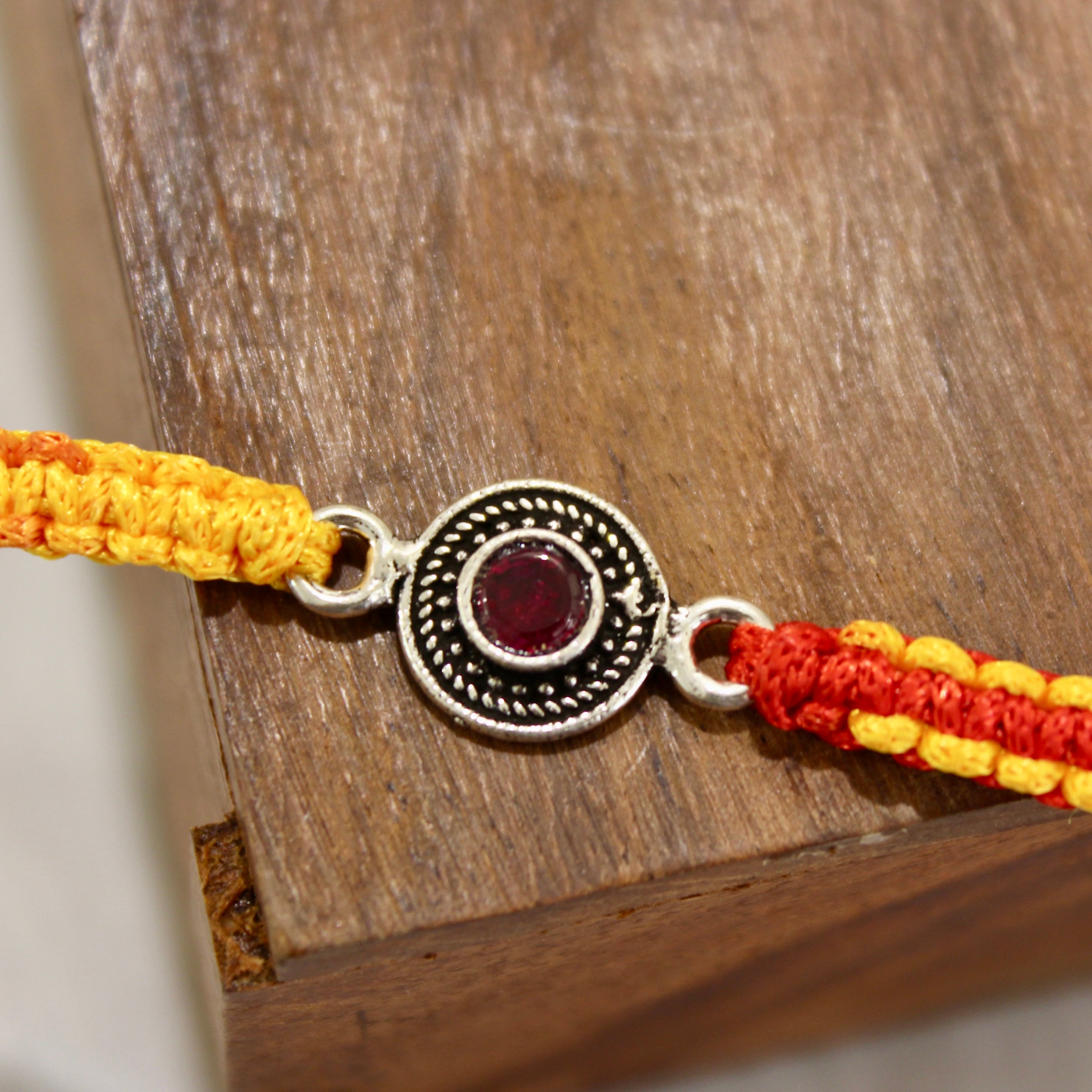 RUBY STONE mini circle red thread rakhi in 925 silver