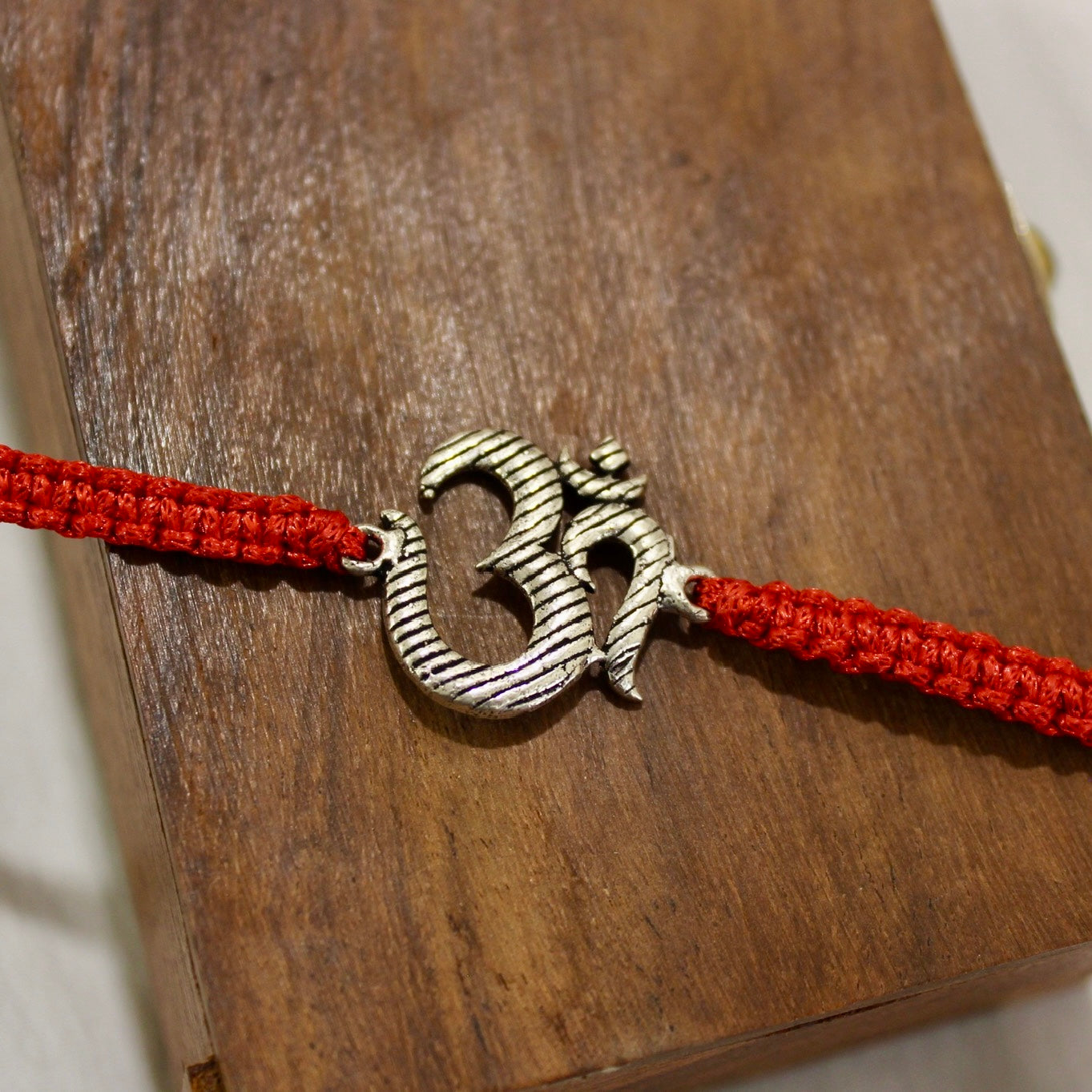 BIG OM red thread rakhi in 925 silver