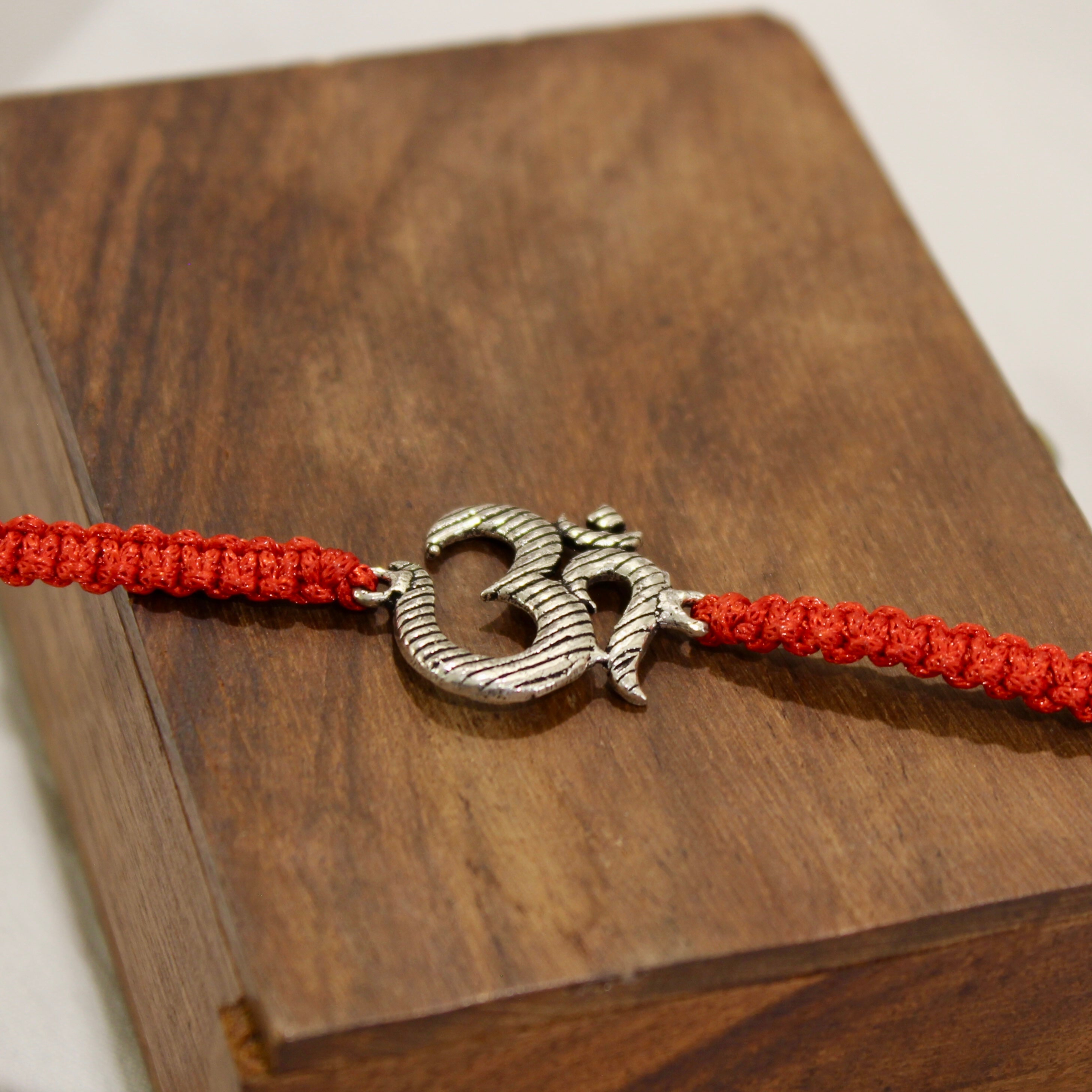 BIG OM red thread rakhi in 925 silver