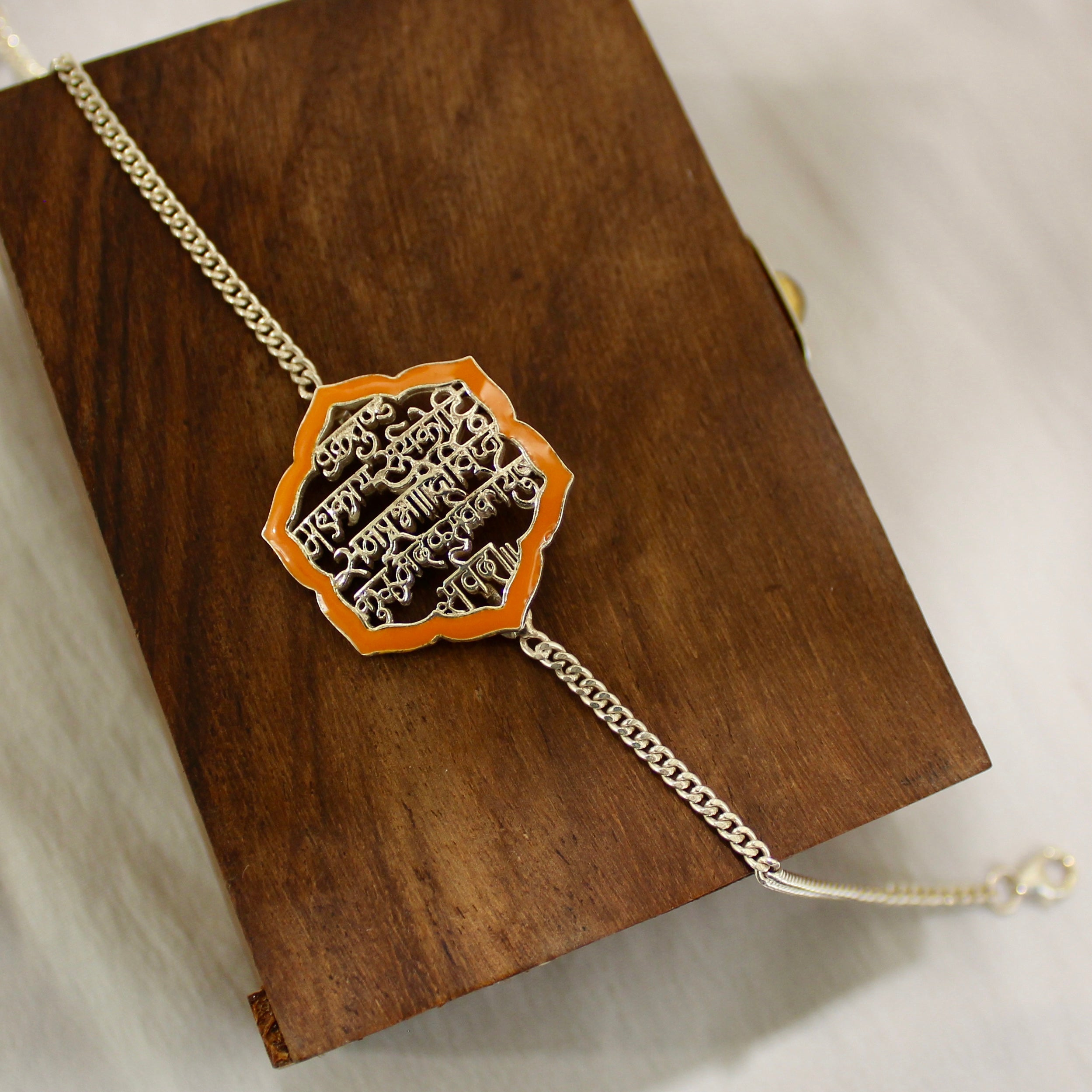 SHLOK orange chained rakhi in 925 silver
