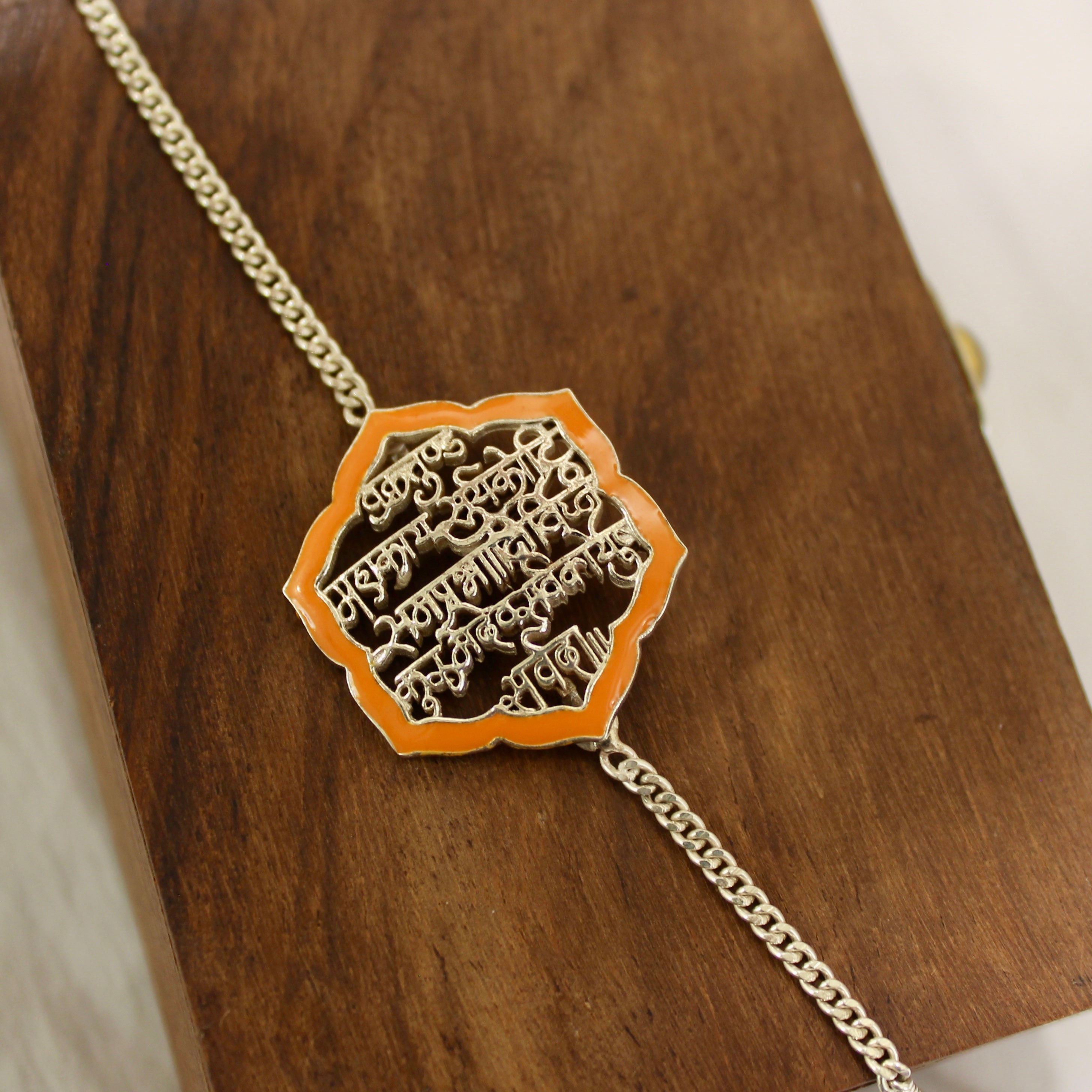SHLOK orange chained rakhi in 925 silver