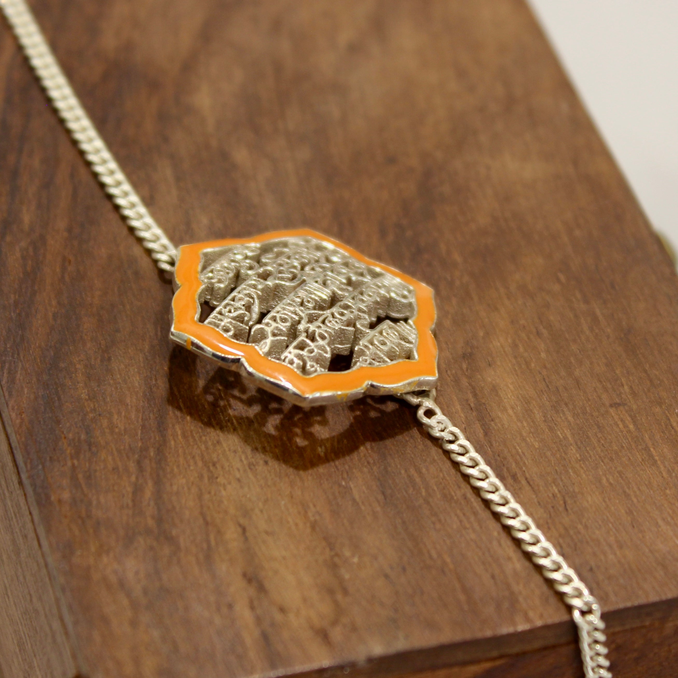 SHLOK orange chained rakhi in 925 silver