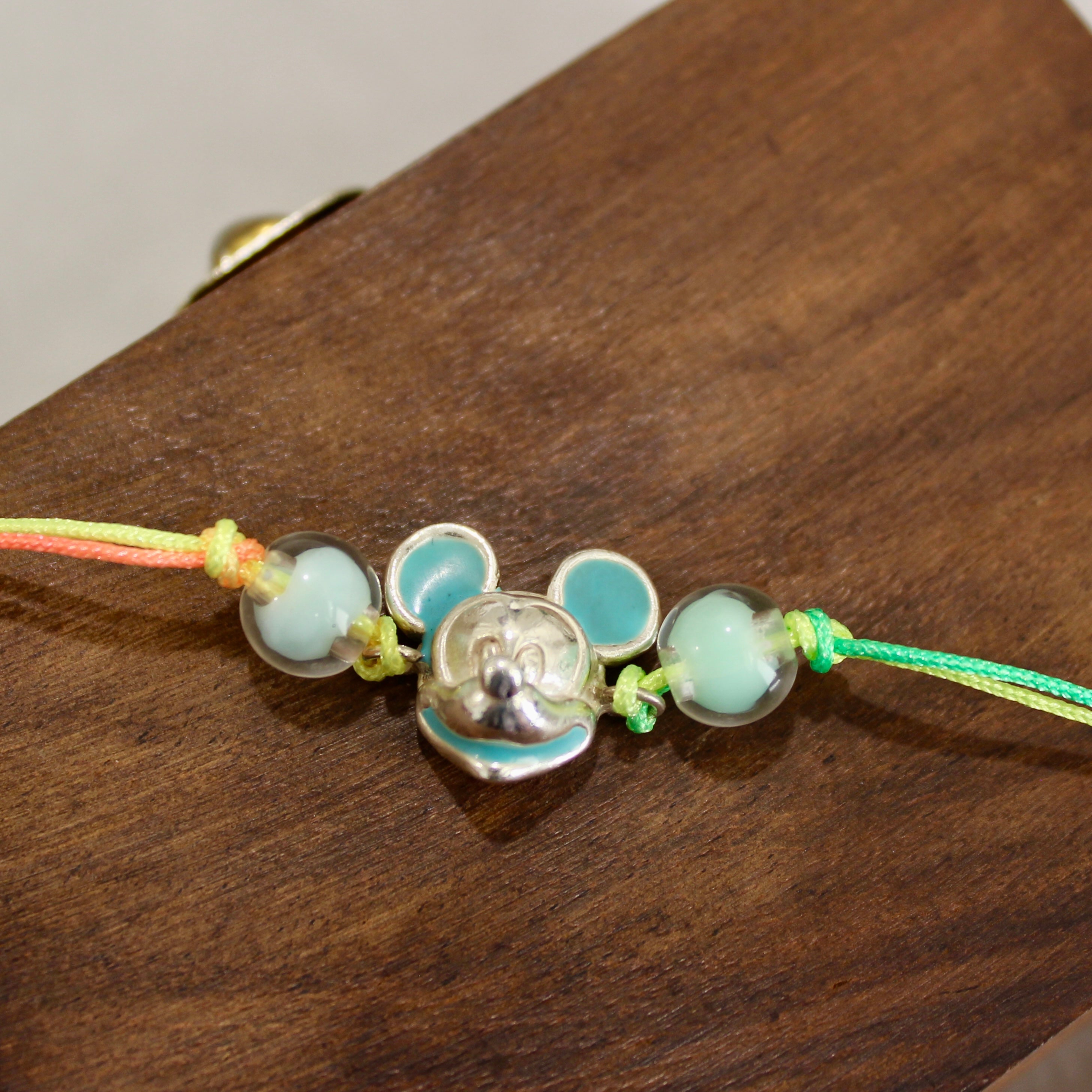 Mickey multi-colored thread rakhi in 925 silver