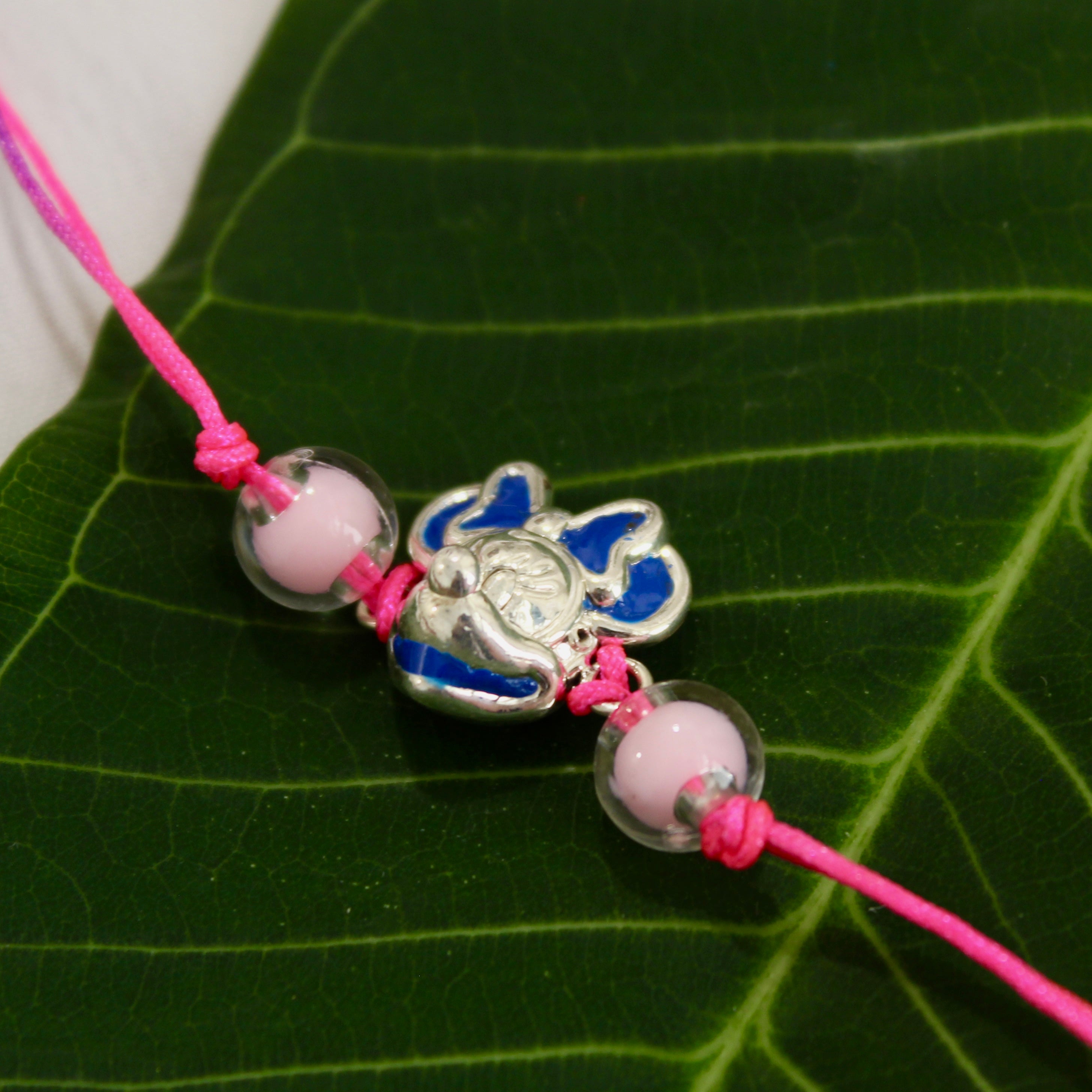 Mini pink thread rakhi in 925 silver