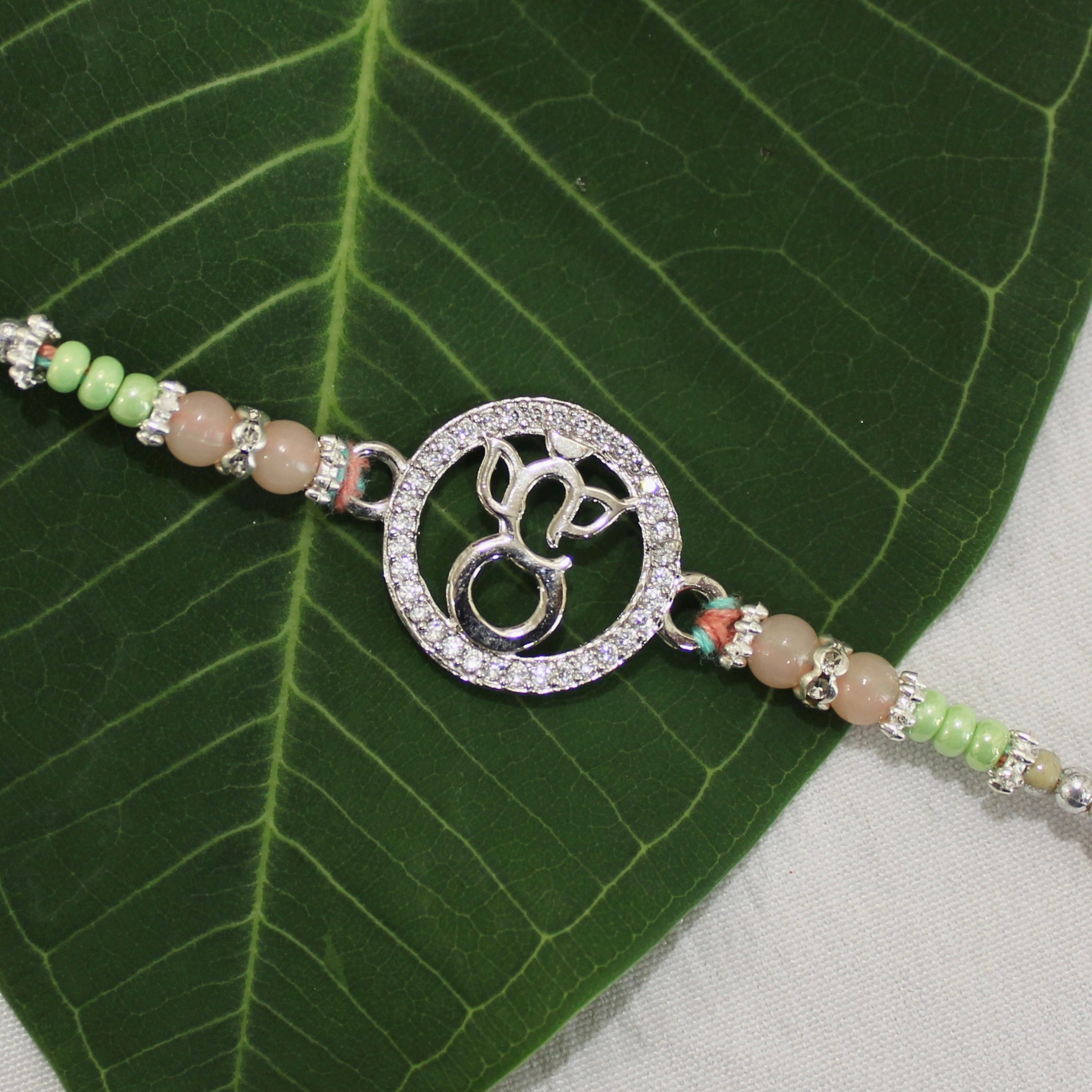 LORD GANESHA IN CIRCLE 925 silver peach thread rakhi