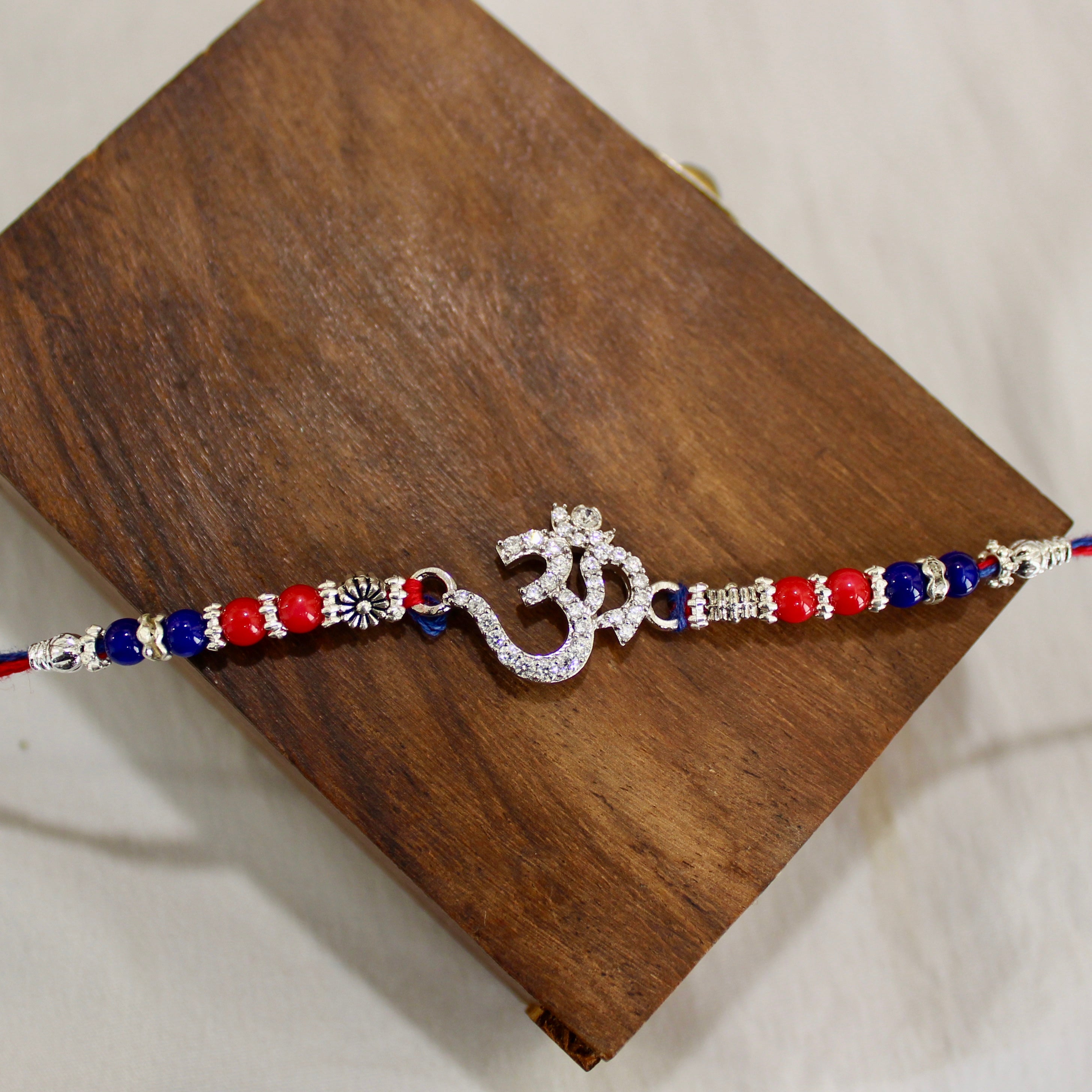 OM WITH ZIRCON STONES 925 silver red thread rakhi
