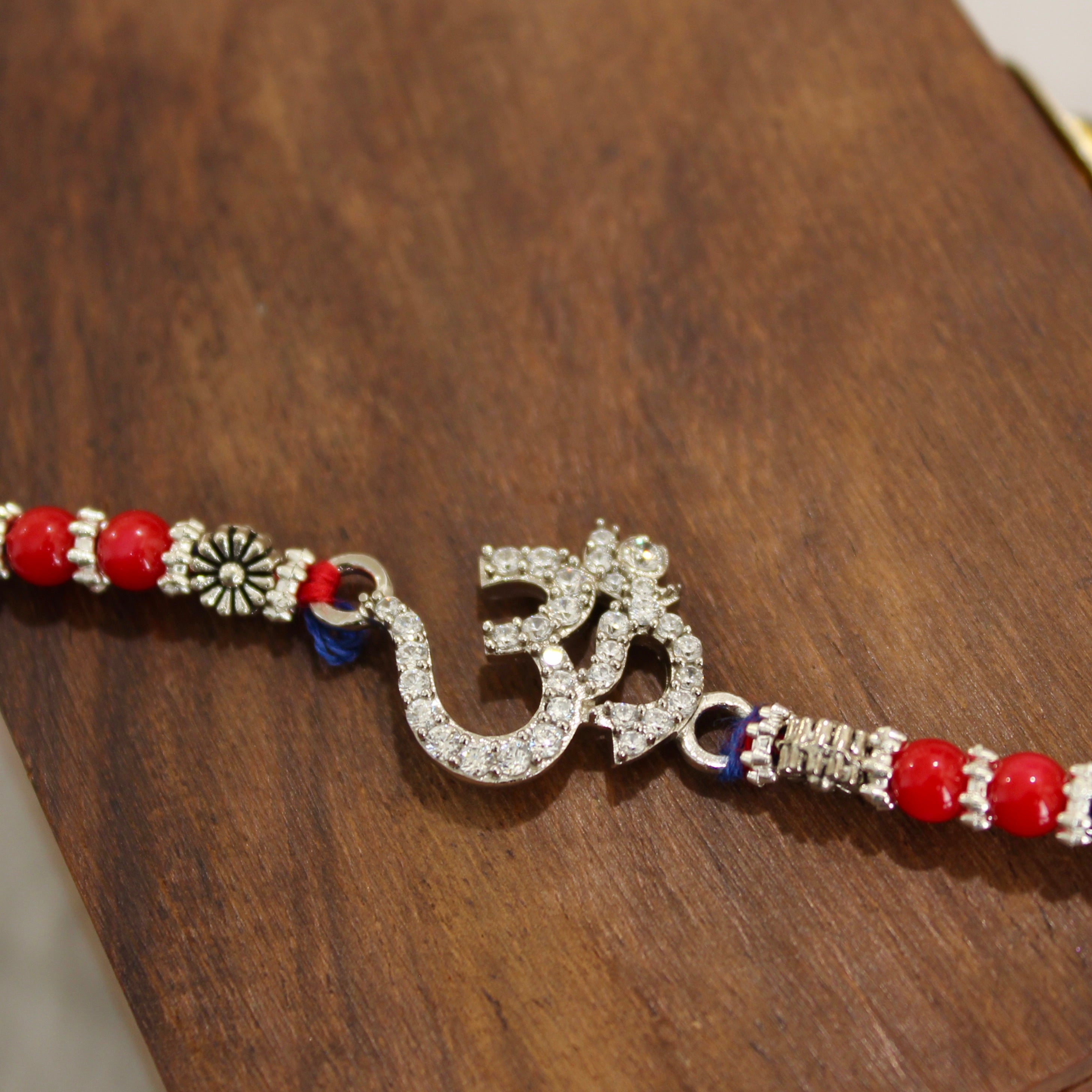 OM WITH ZIRCON STONES 925 silver red thread rakhi