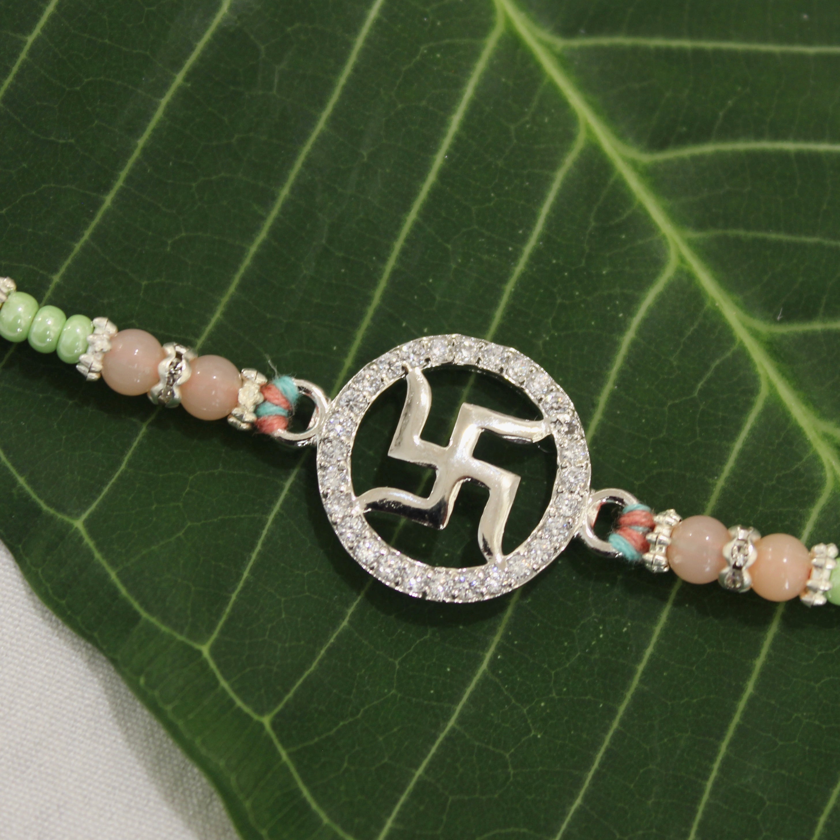 SATIYA peach thread Rakhi in 925 silver