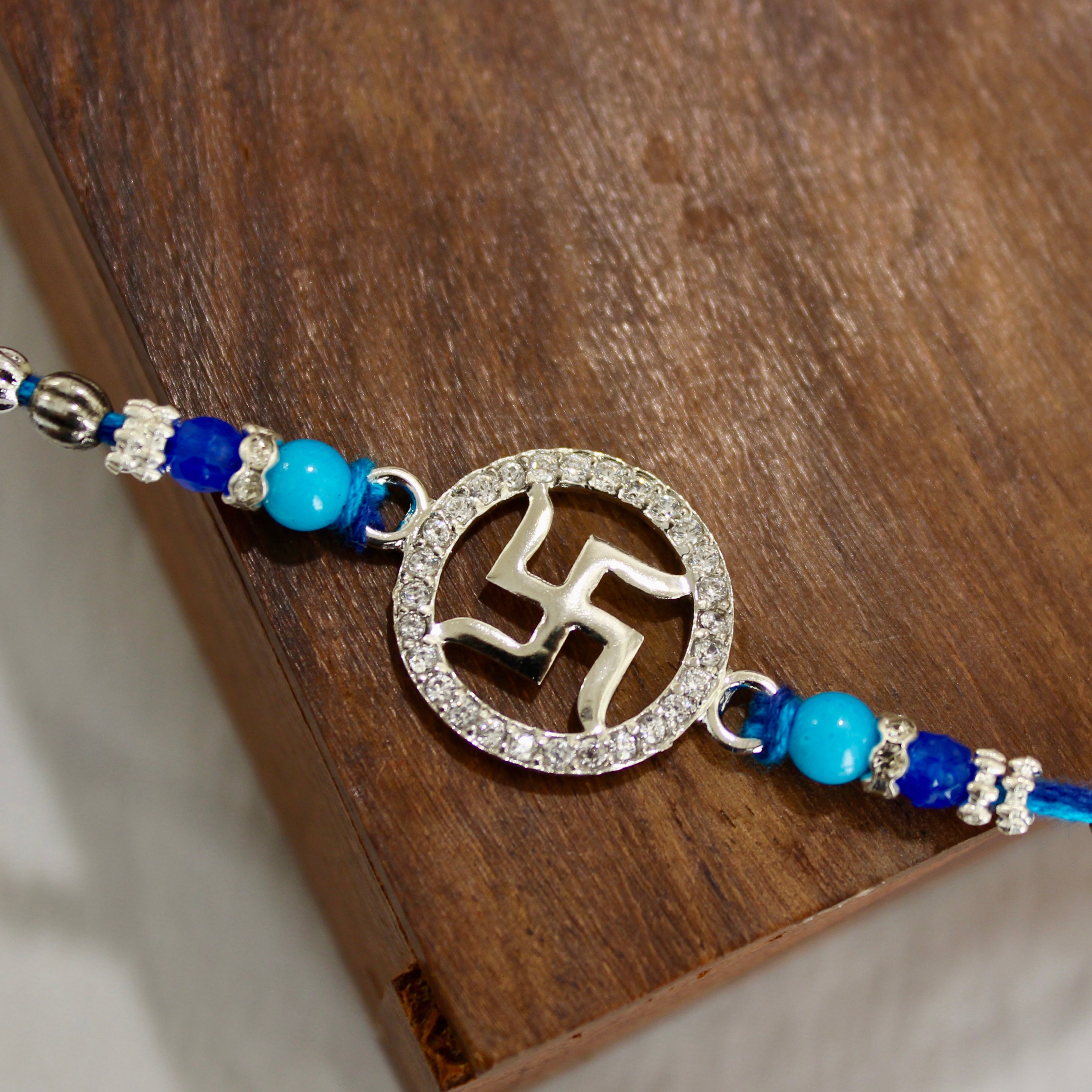 Satiya in circle blue thread rakhi in 925 silver