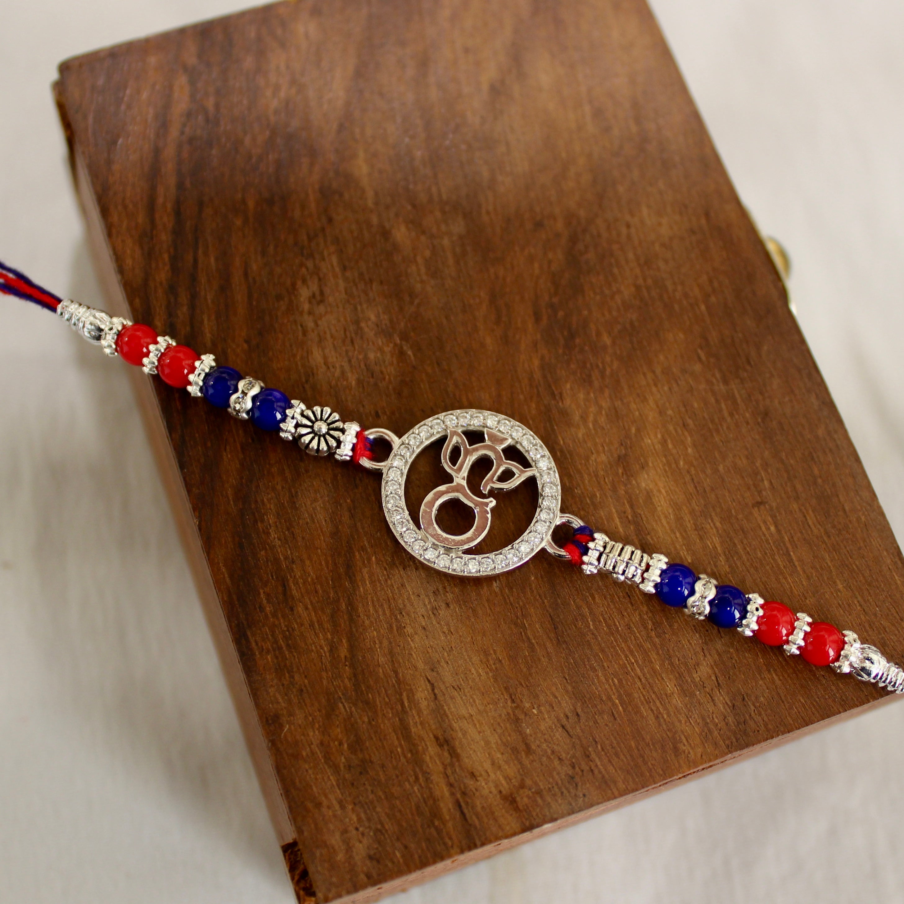 LORD GANESHA IN CIRCLE 925 silver red thread rakhi