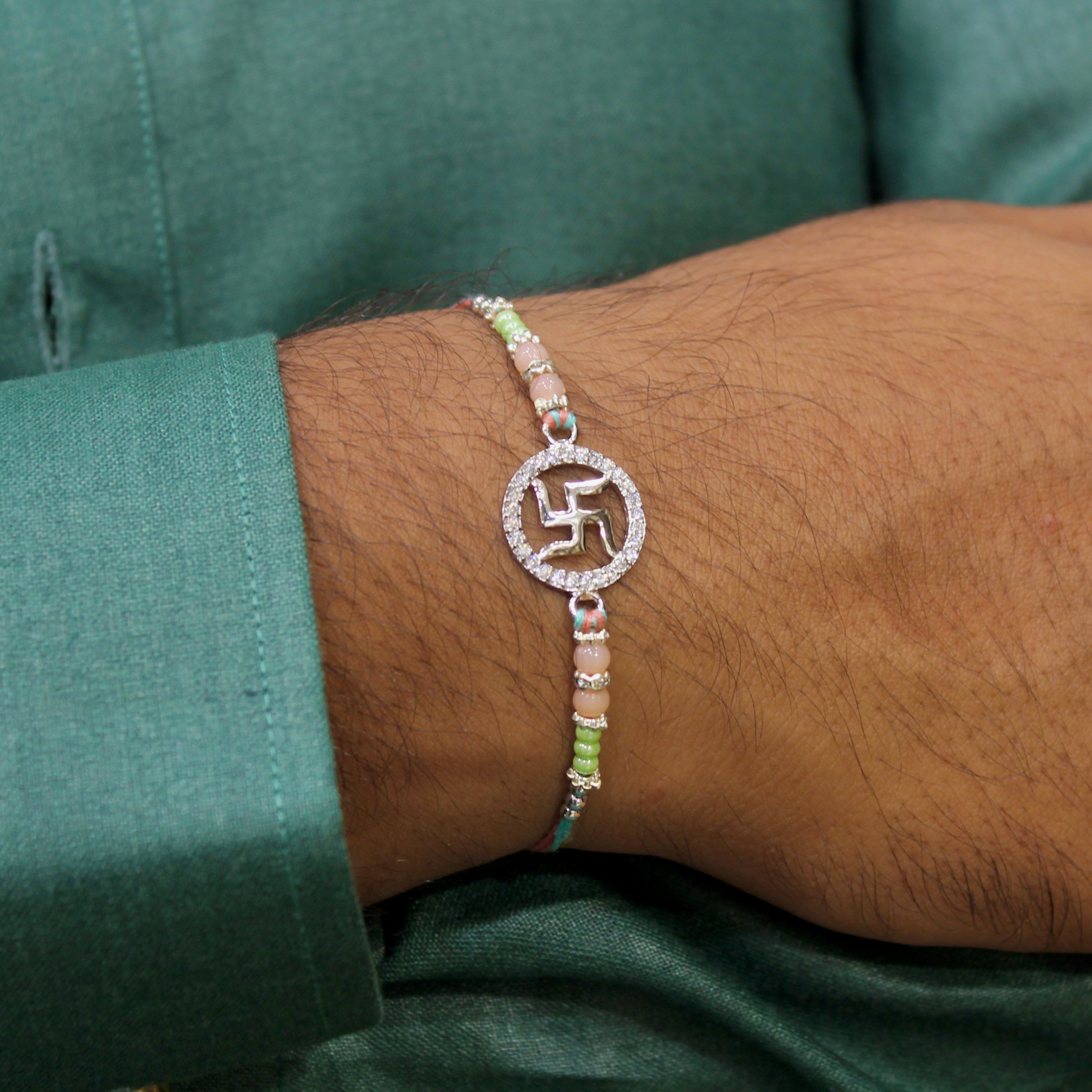 SATIYA peach thread Rakhi in 925 silver