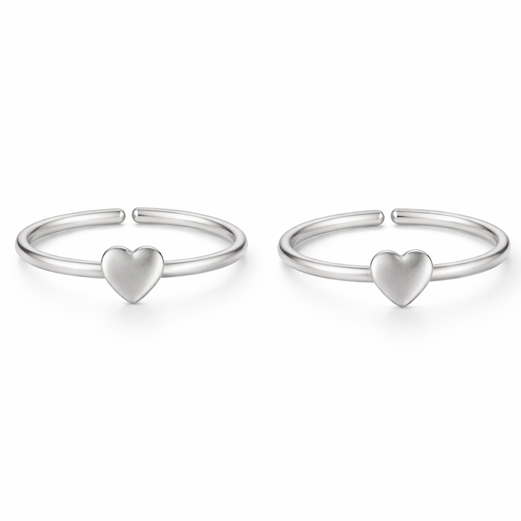 Two silver heart-shaped bangle charms on a white background