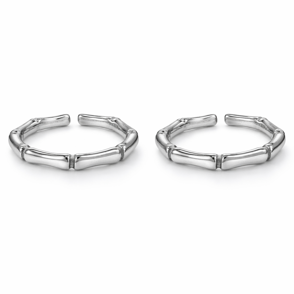 Pair of silver bamboo-style hoop earrings on a white background