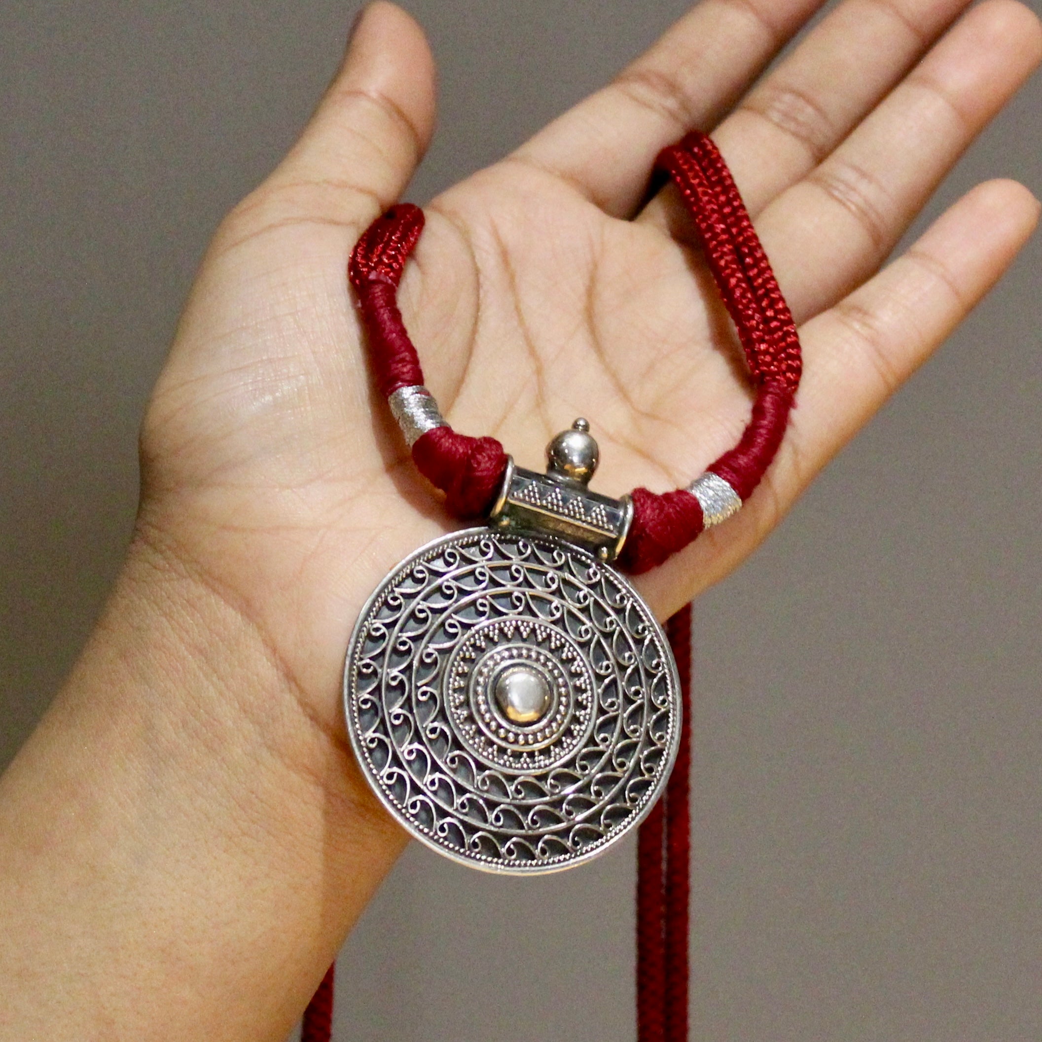 Oxidised circle pattered 925 silver with red dori necklace