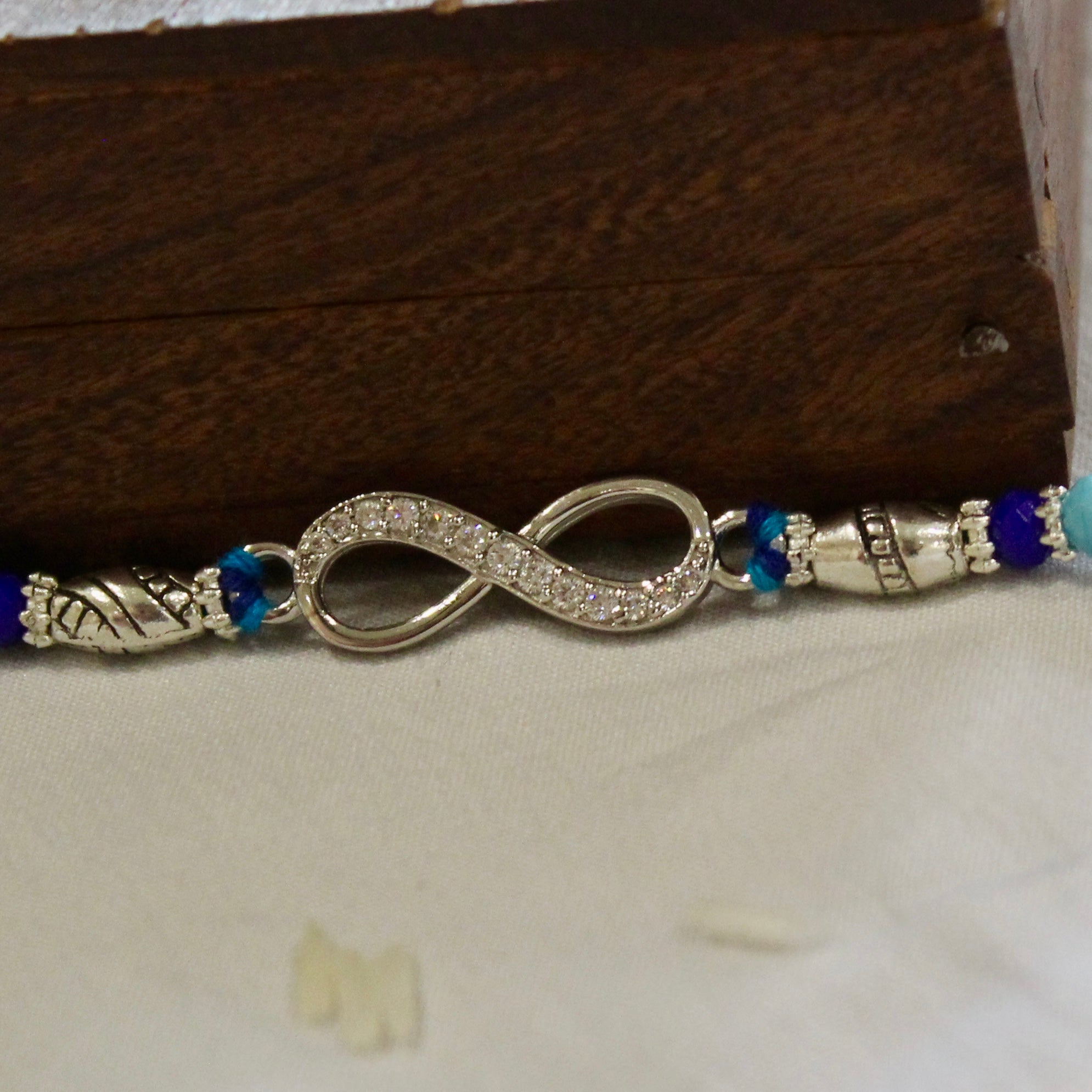 Infinity silver blue thread rakhi