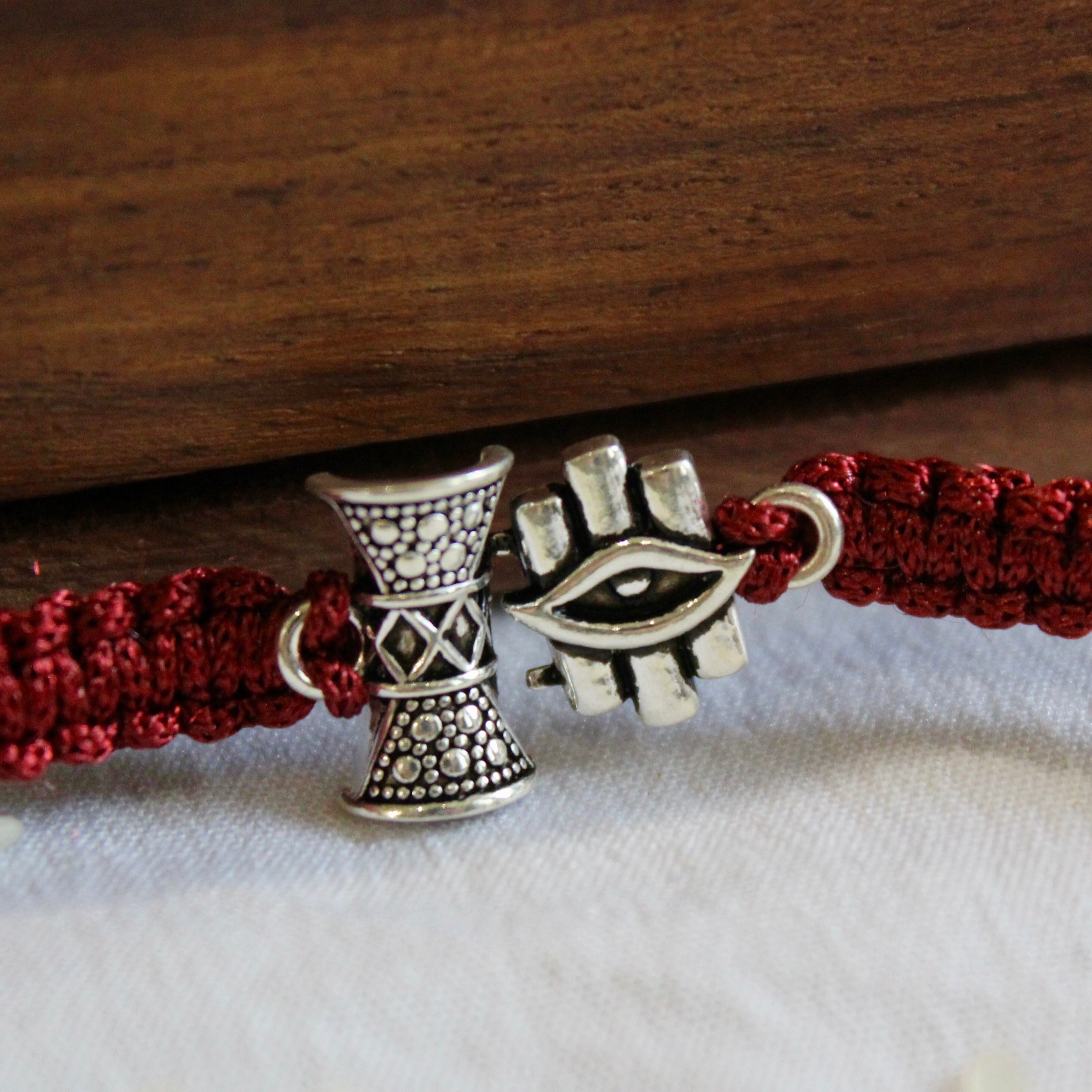 SHiv Damru and Eye Maroon Thread Silver Rakhi