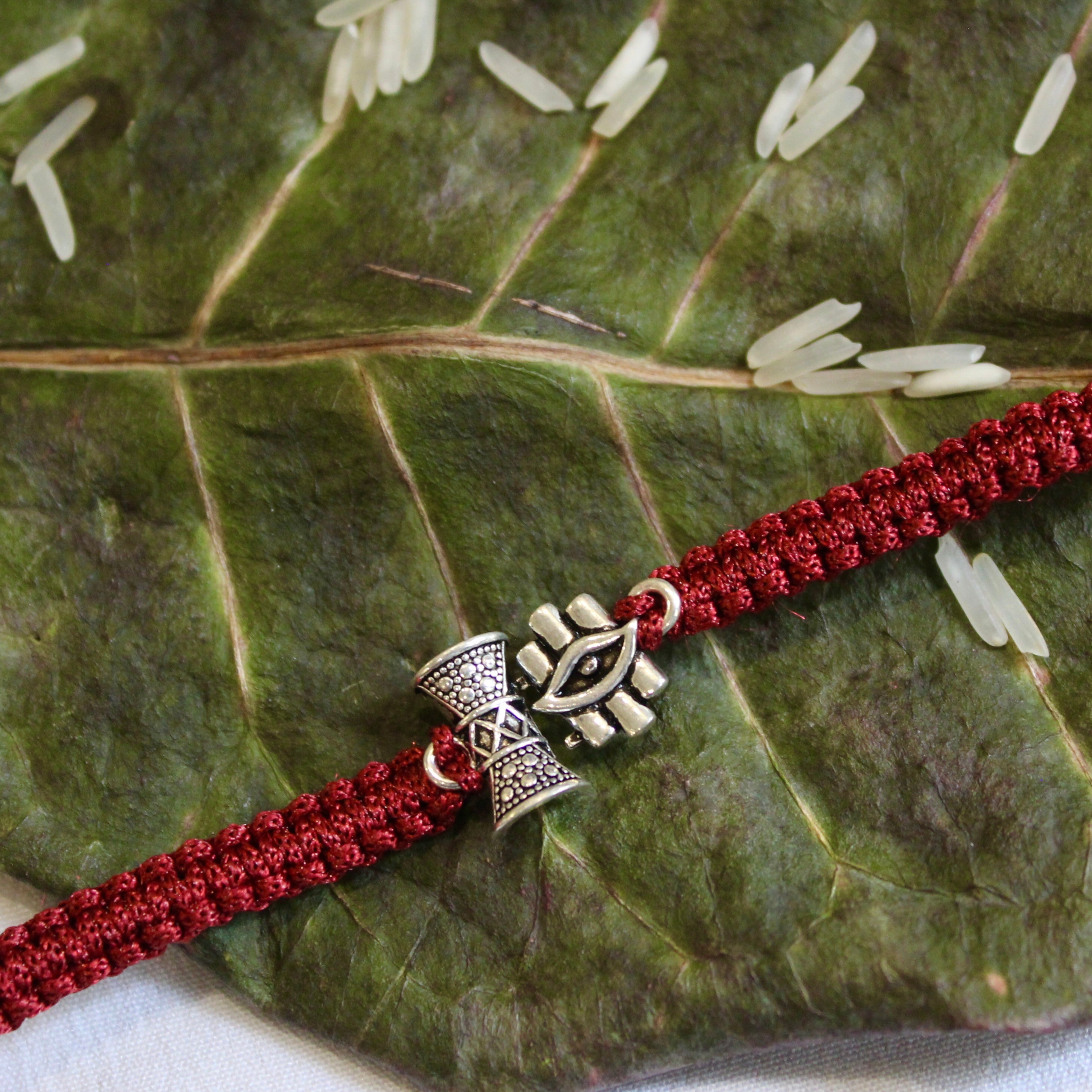 SHiv Damru and Eye Maroon Thread Silver Rakhi