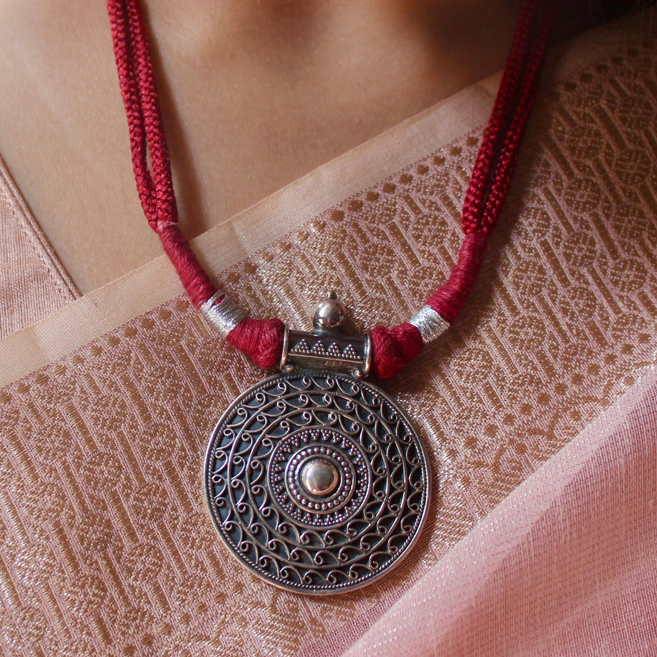 Oxidised circle pattered 925 silver with red dori necklace