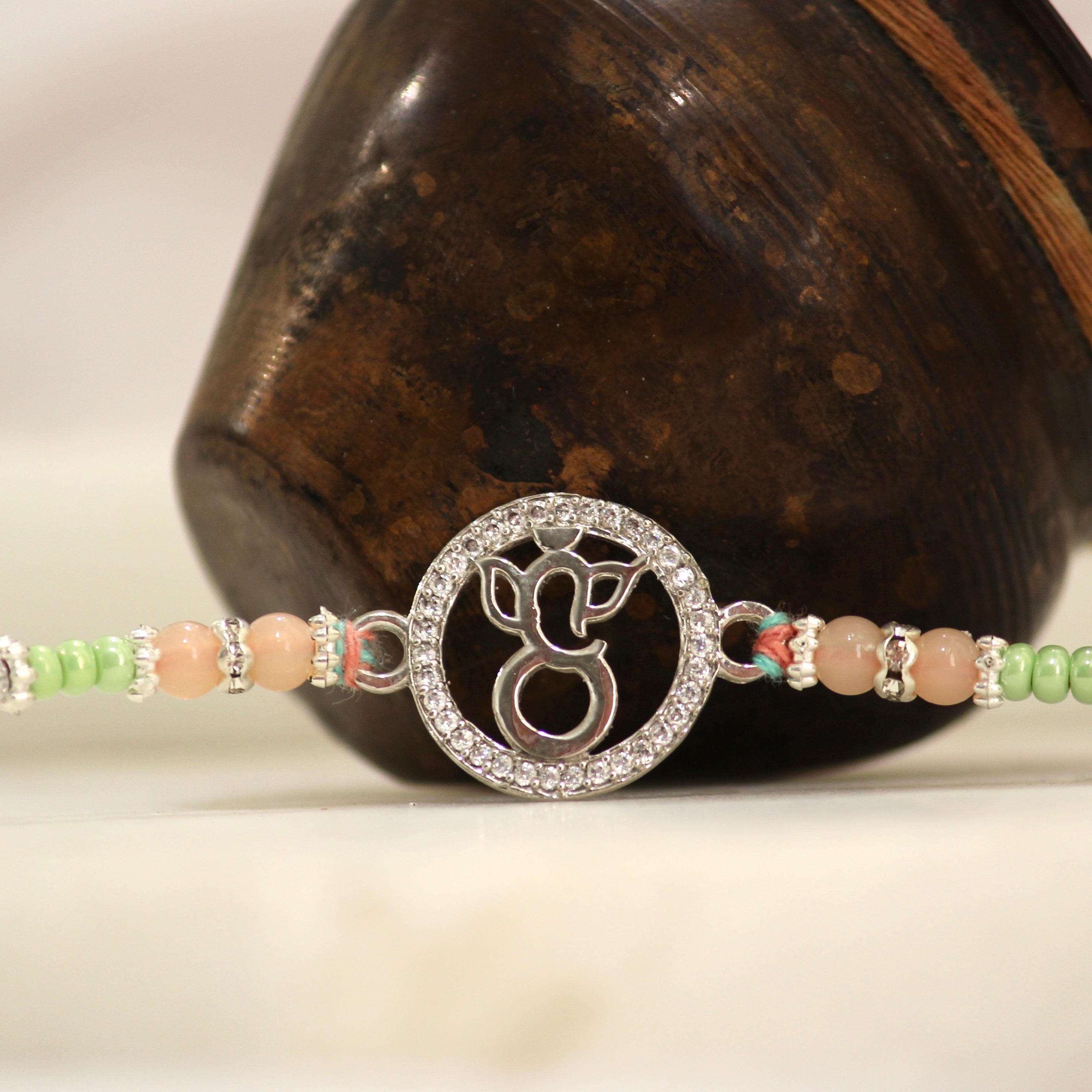 LORD GANESHA IN CIRCLE 925 silver peach thread rakhi