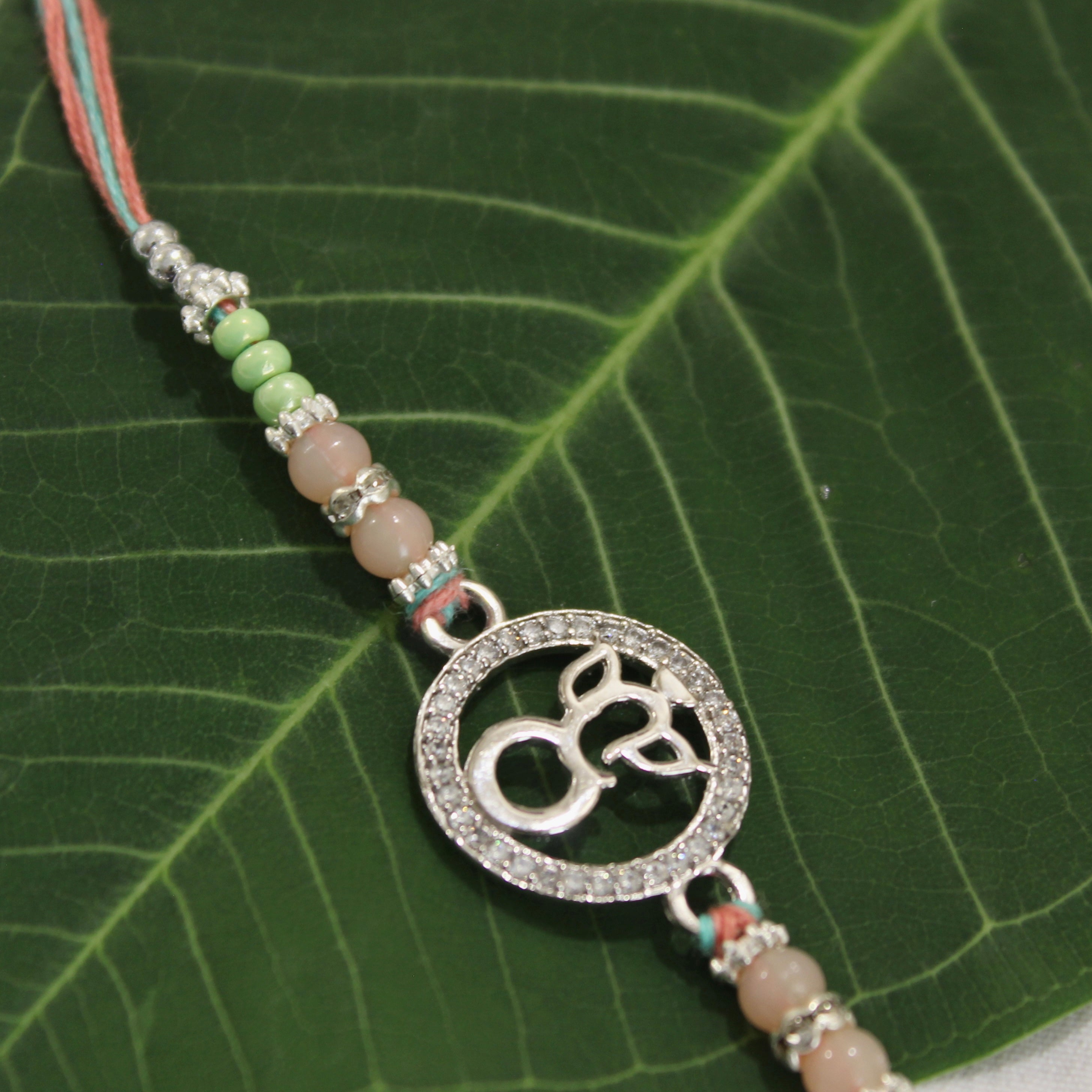 LORD GANESHA IN CIRCLE 925 silver peach thread rakhi
