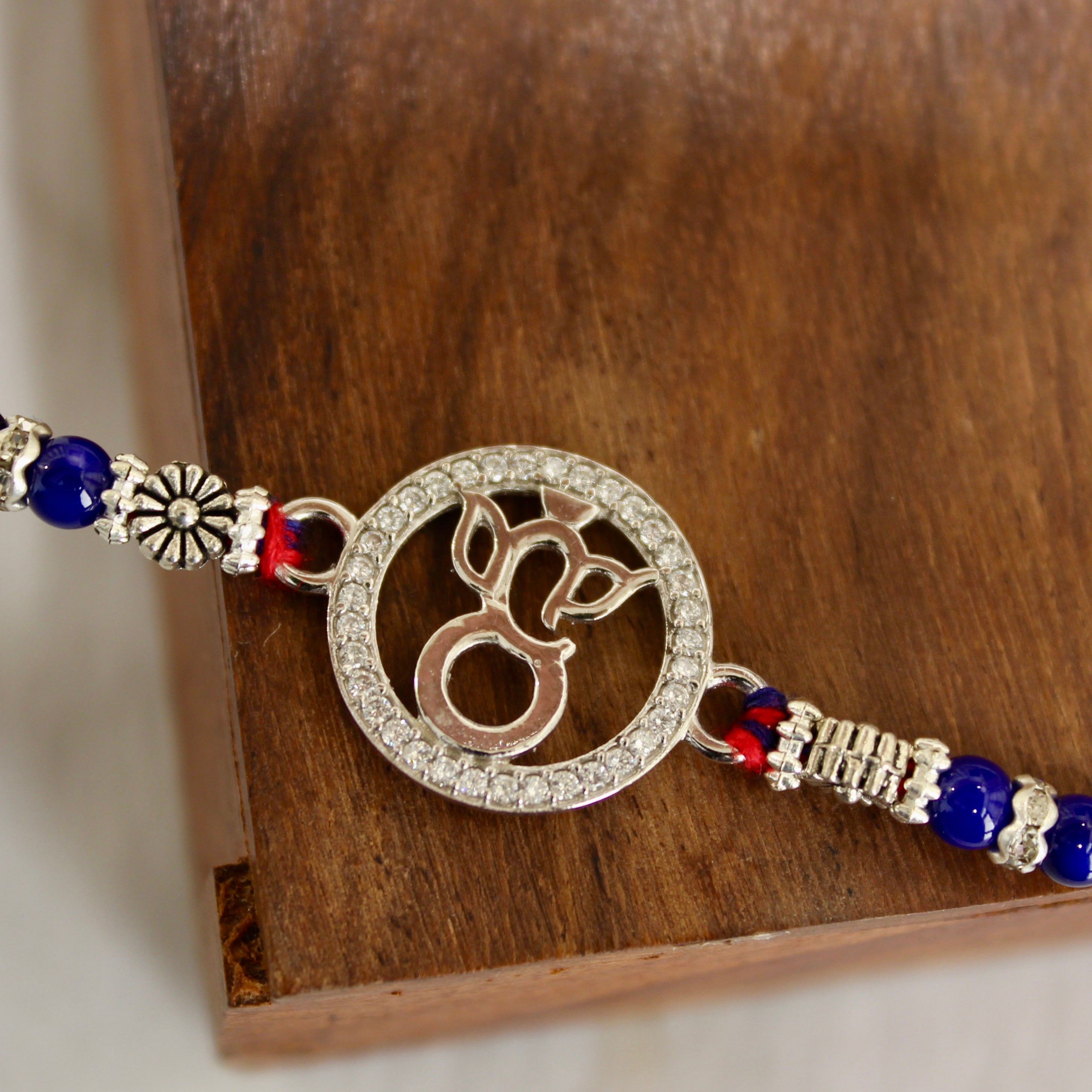 LORD GANESHA IN CIRCLE 925 silver red thread rakhi