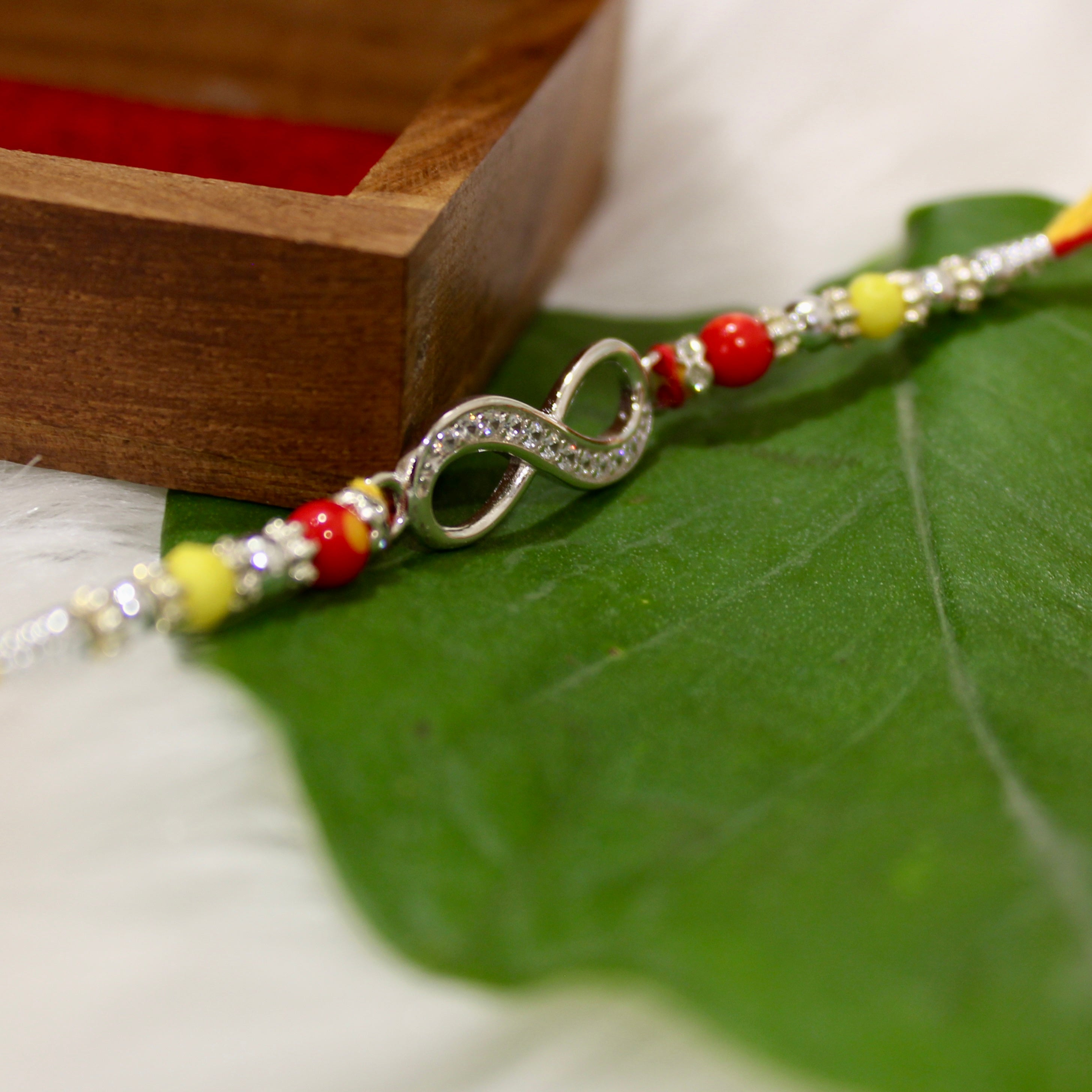 Infinity Silver Yellow Red Thread Rakhi In 925 Silver