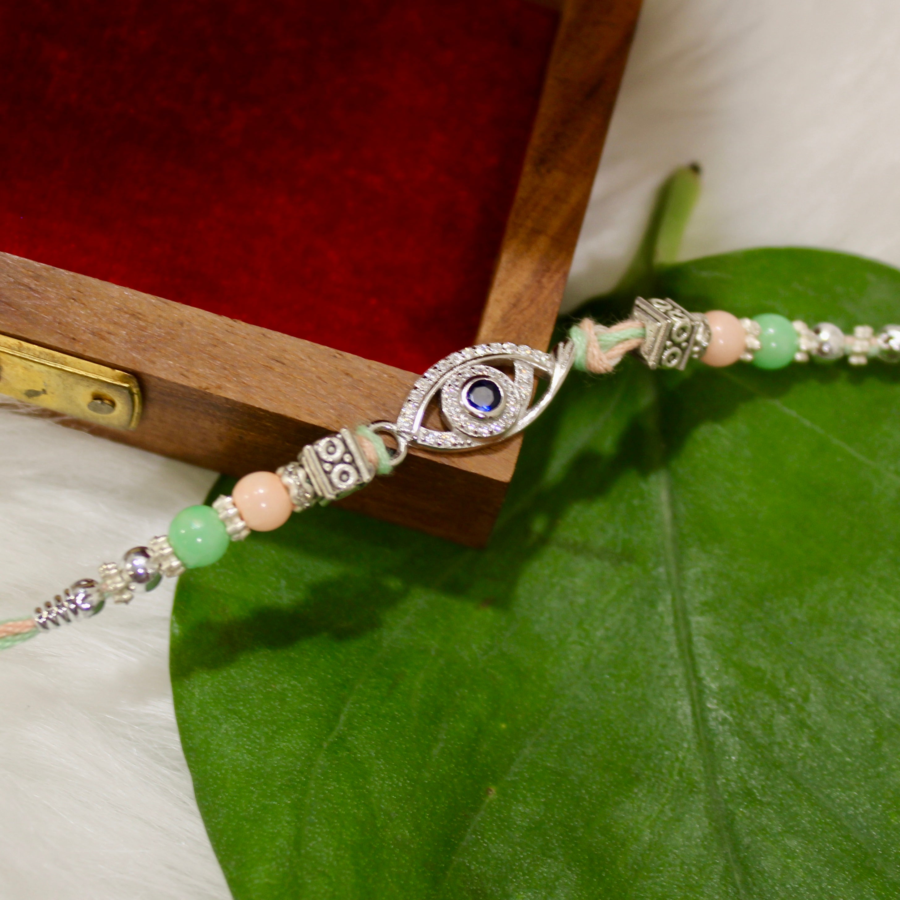 Evil Eye Charm Green Thread Rakhi In 925 Silver
