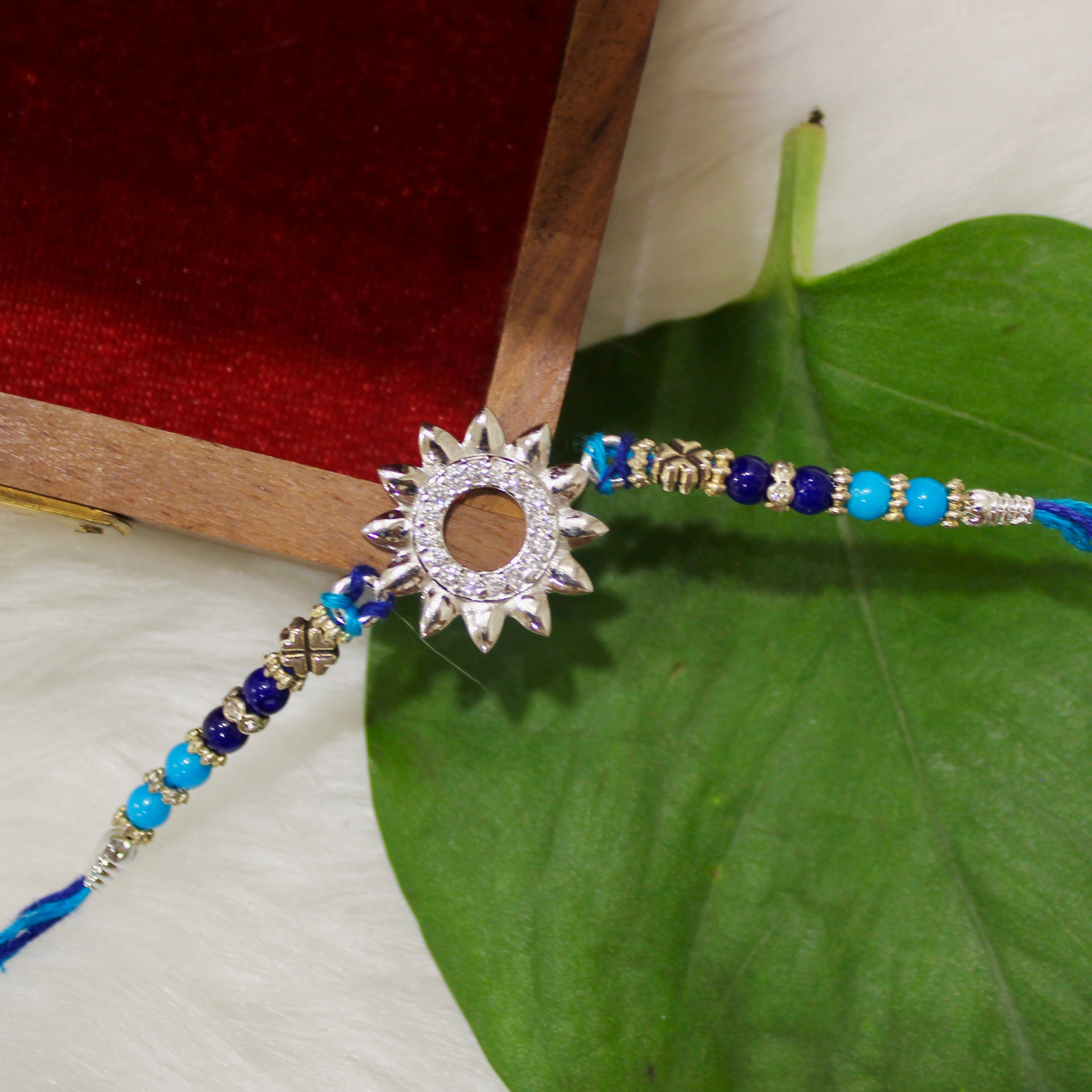 Sun Charm Blue Thread Rakhi In 925 Silver