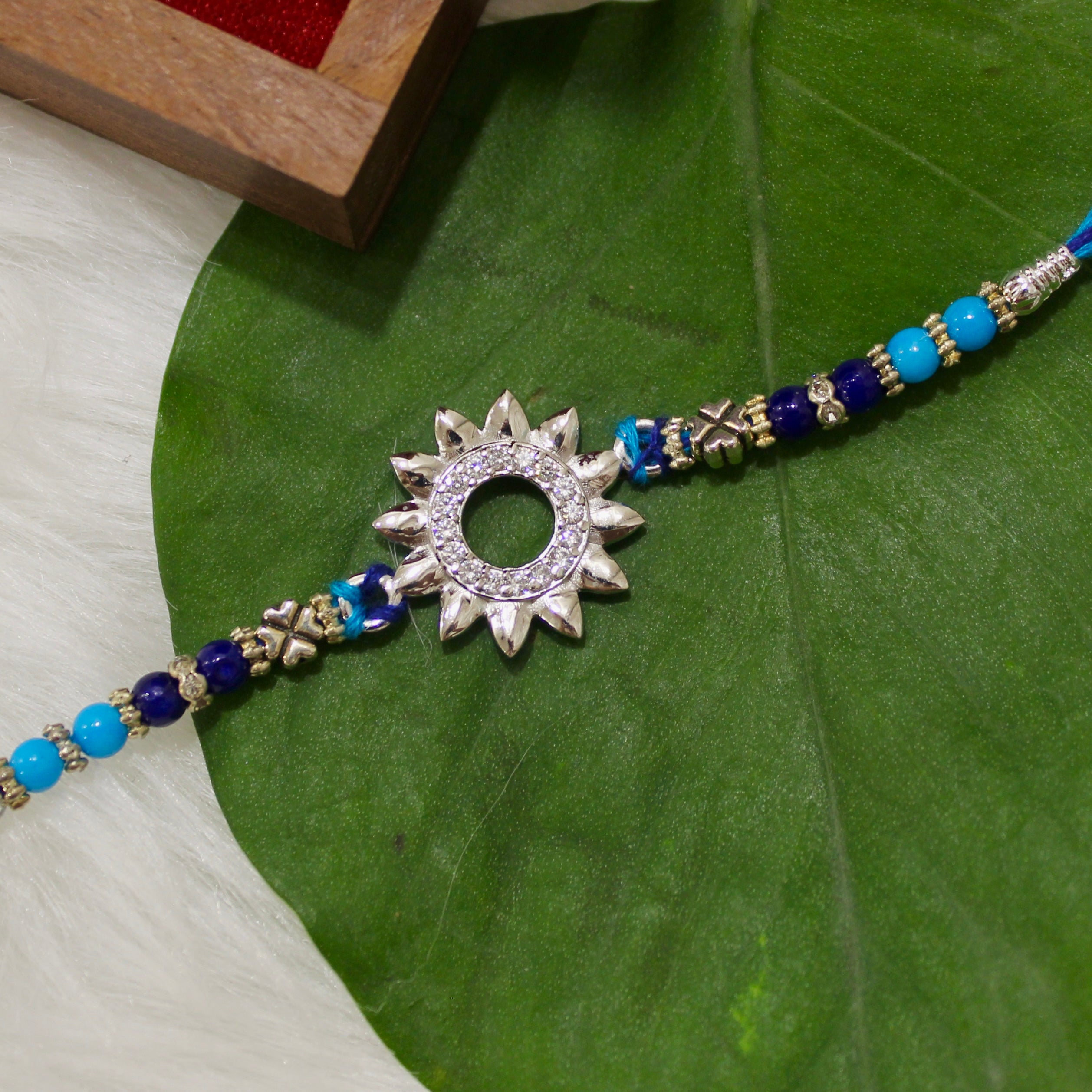 Sun Charm Blue Thread Rakhi In 925 Silver