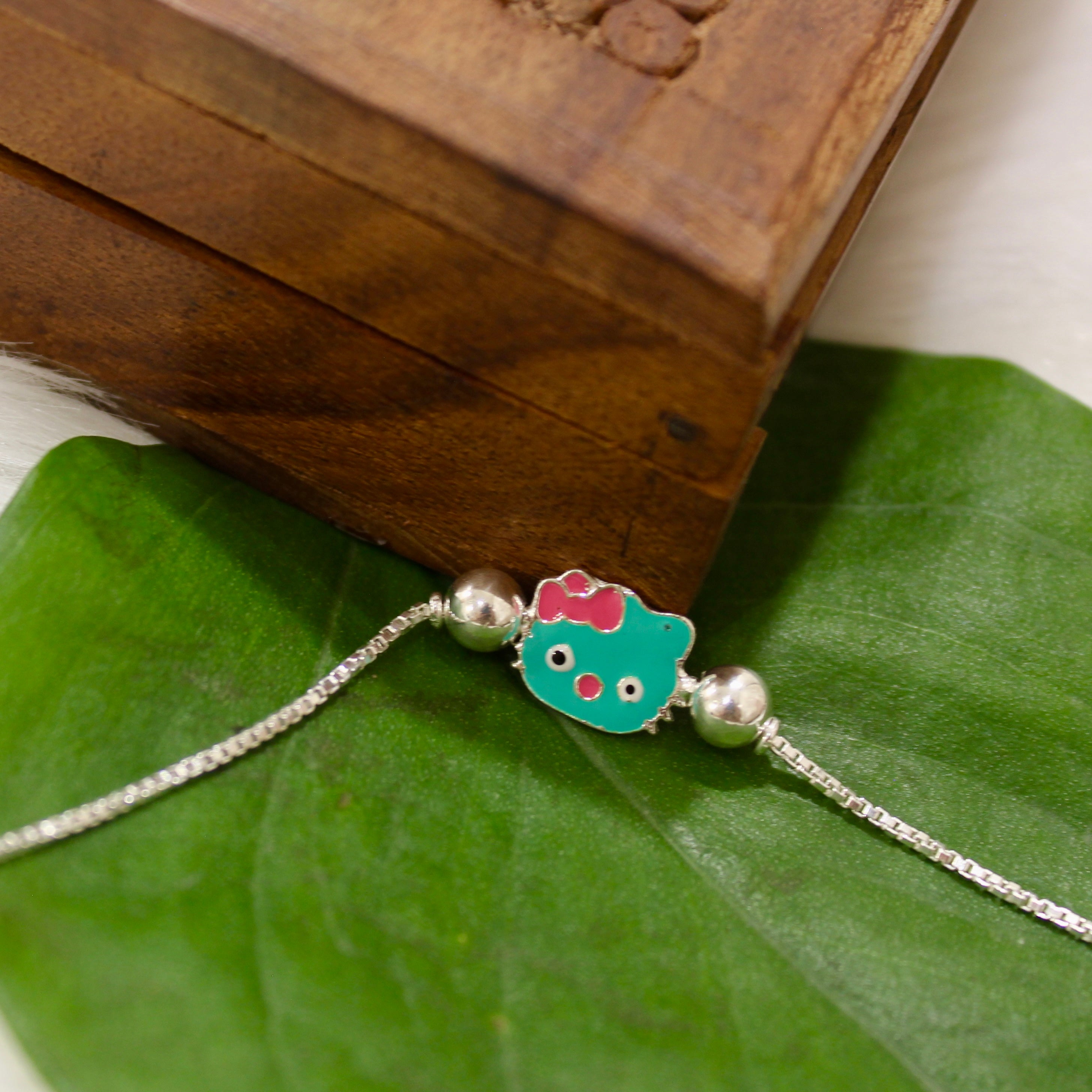 Green Hello Kitty Chained Kids Rakhi In 925 Silver