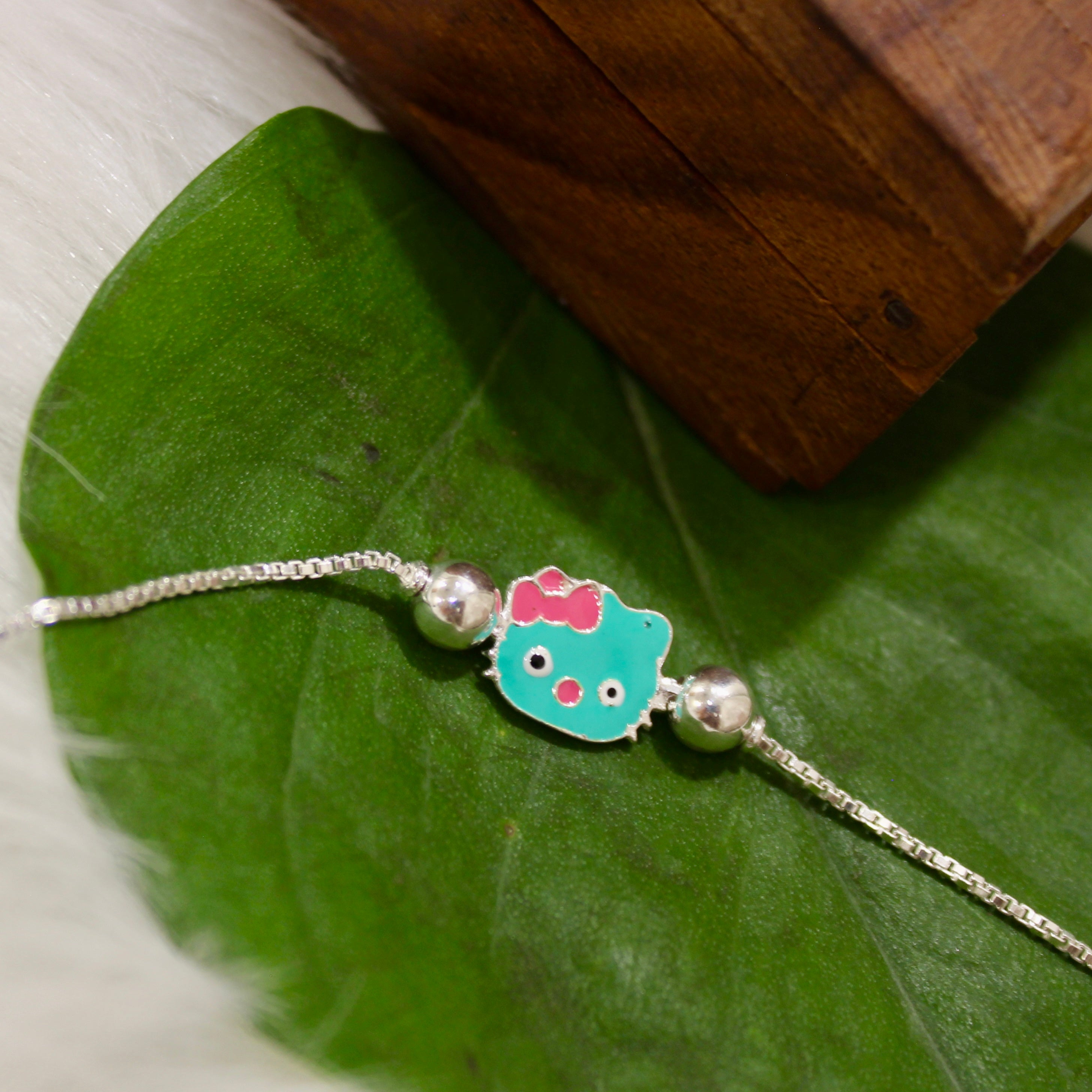 Green Hello Kitty Chained Kids Rakhi In 925 Silver