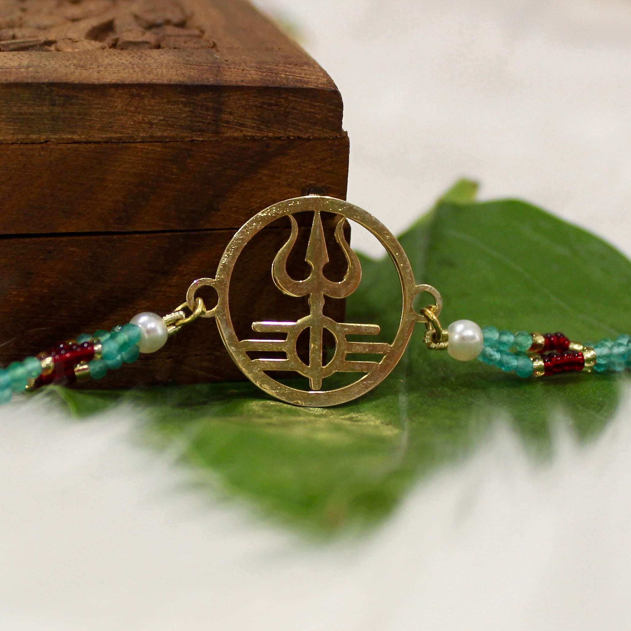 Trishul In Circle Gold Polish Maroon Thread Rakhi In 925 Silver